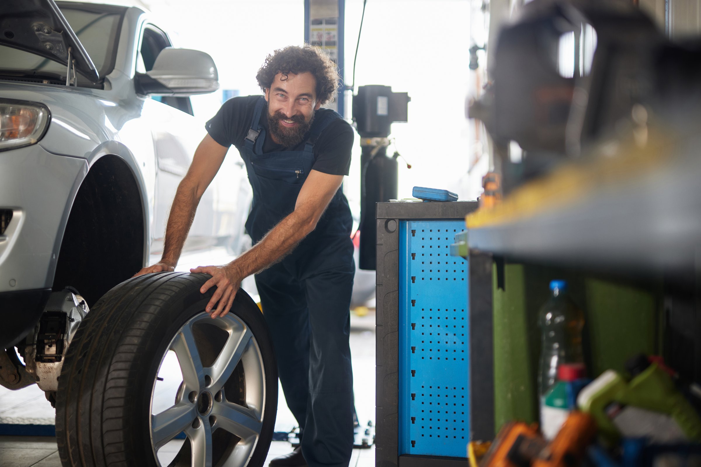Mechanic changing a tire in a professional car repair shop