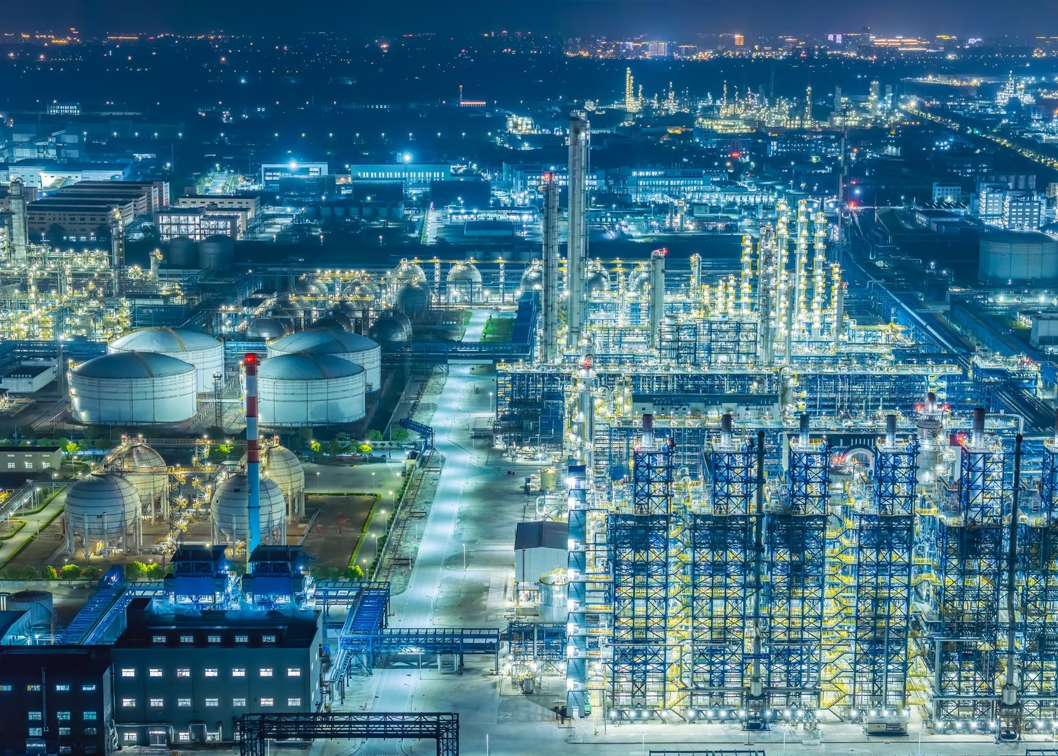 Oil refinery chemical plant industrial equipment buildings at night. Business Finance and Industry