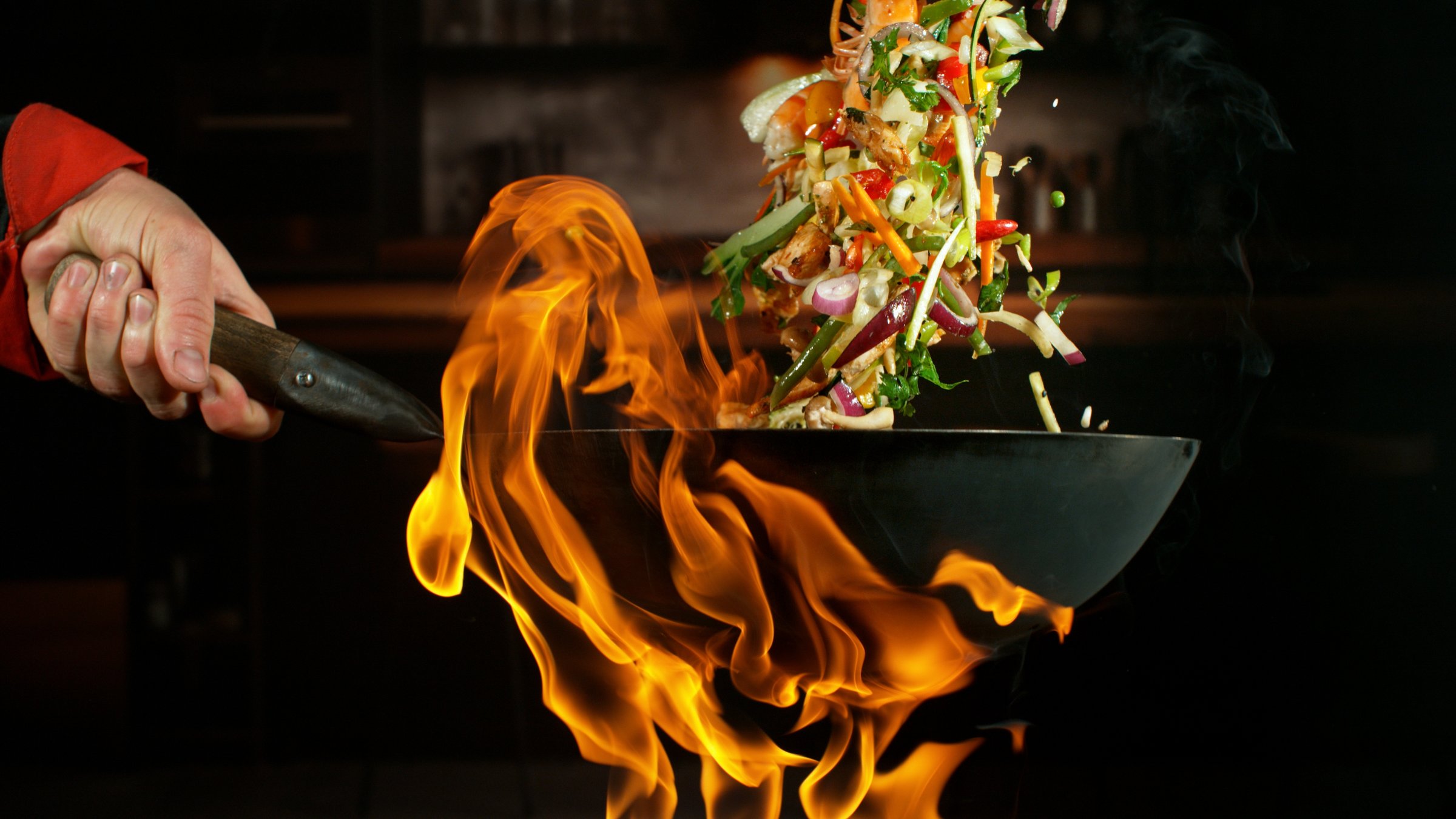 Freeze Motion of Flying Asian Wok Ingredients with Fire Flames