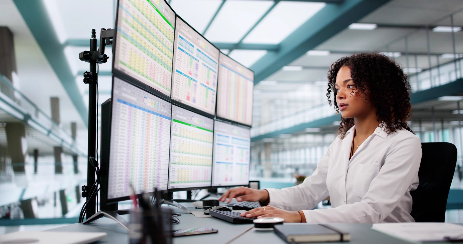 Hospital Doctor Using Spreadsheet For Billing Codes On Desktop