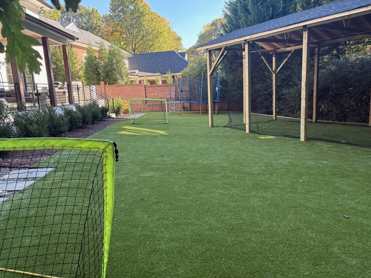Backyard turf and batting cage alternate view