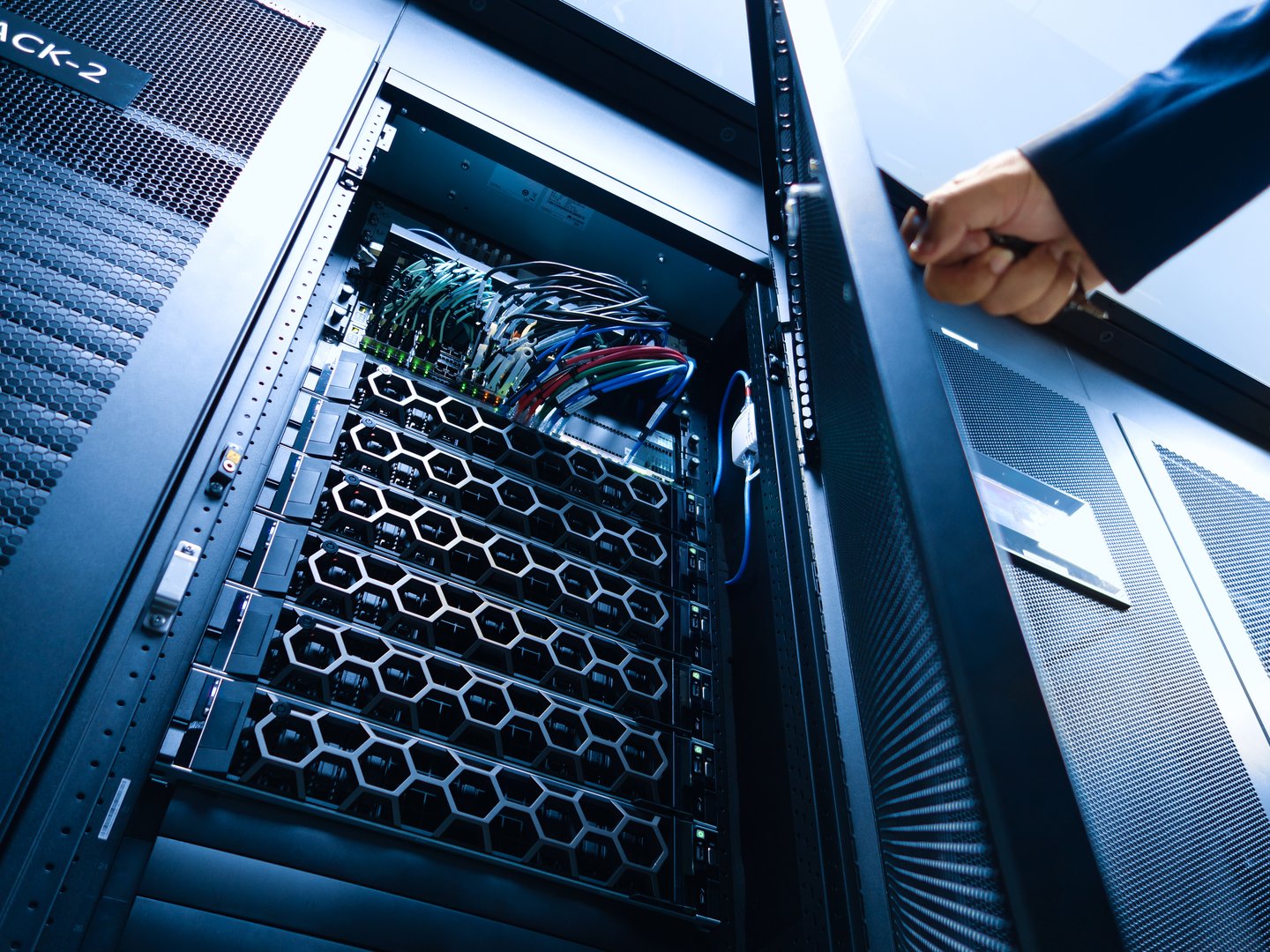 A close-up view of a server rack in a modern data center, showcasing neatly organized cables and advanced hardware, representing high-performance technology.