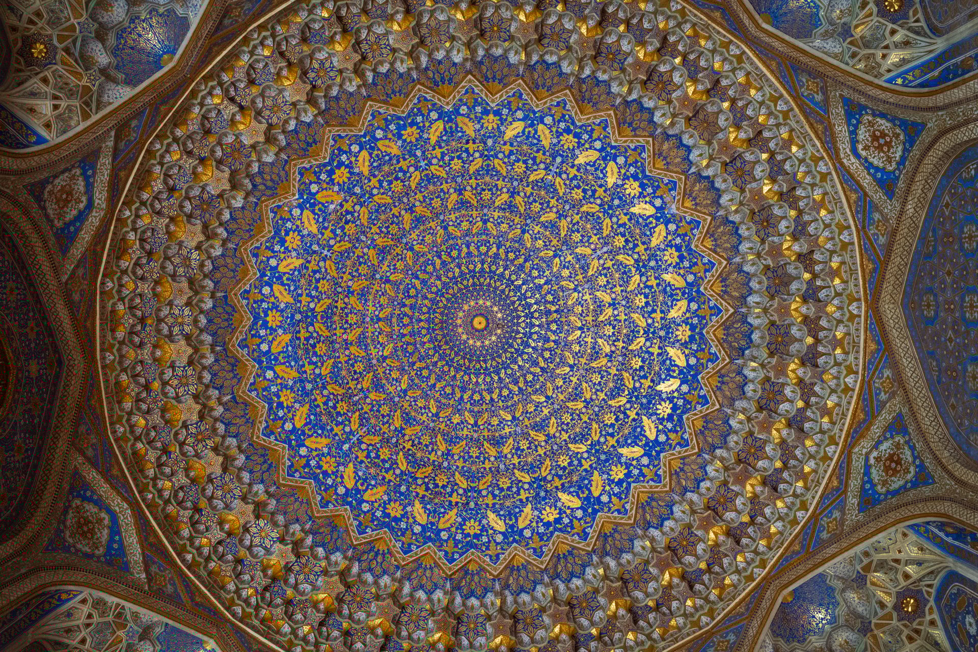 Detailed shot of mosaic patterns and blue tiles of Sher-Dor Madrasa in Registan Square, Samarkand, Uzbekistan, symbol of Timurid architecture.