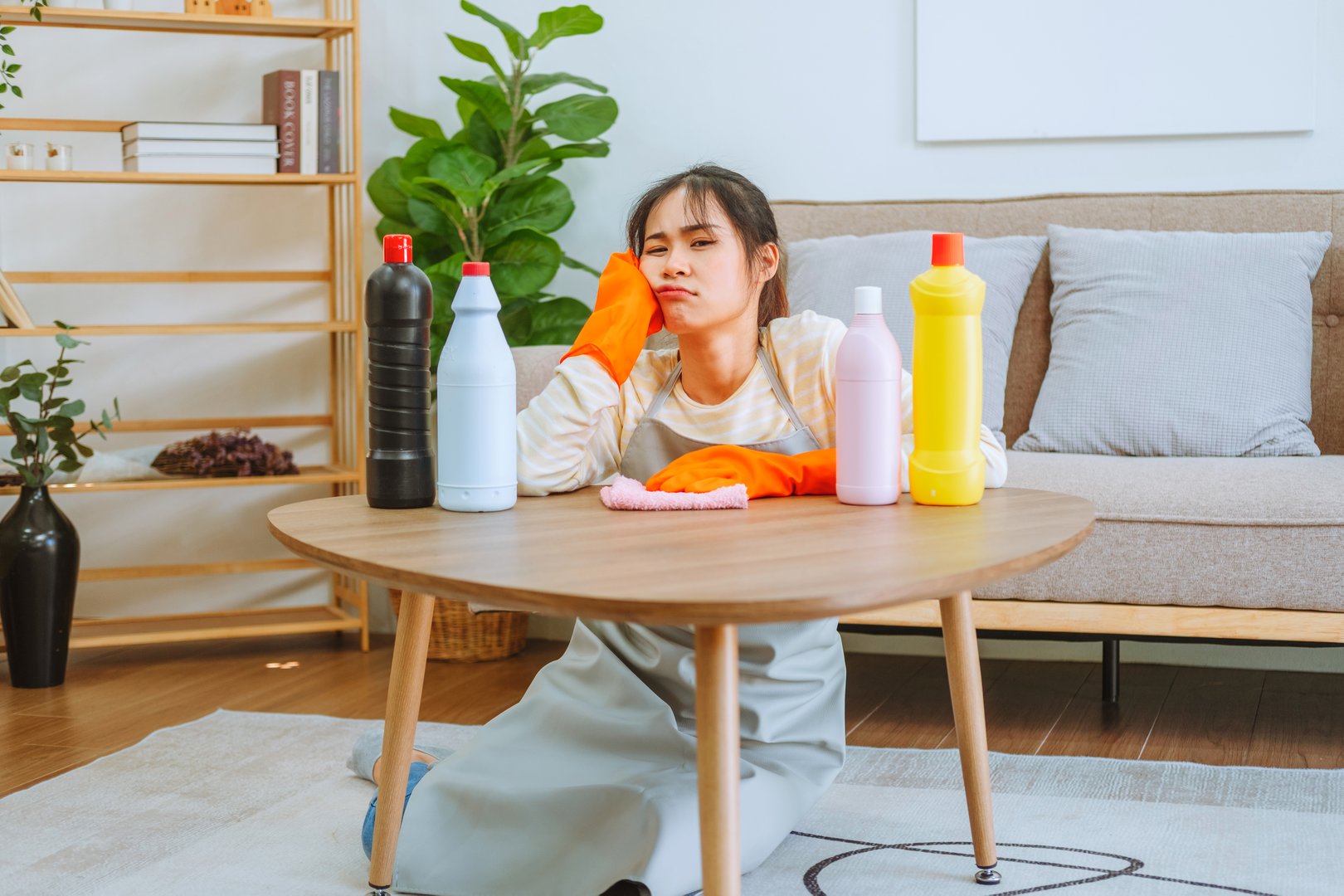 Stressed woman overwhelmed by DIY rug cleaning chores - why professional rug cleaning saves time and effort in Atlanta