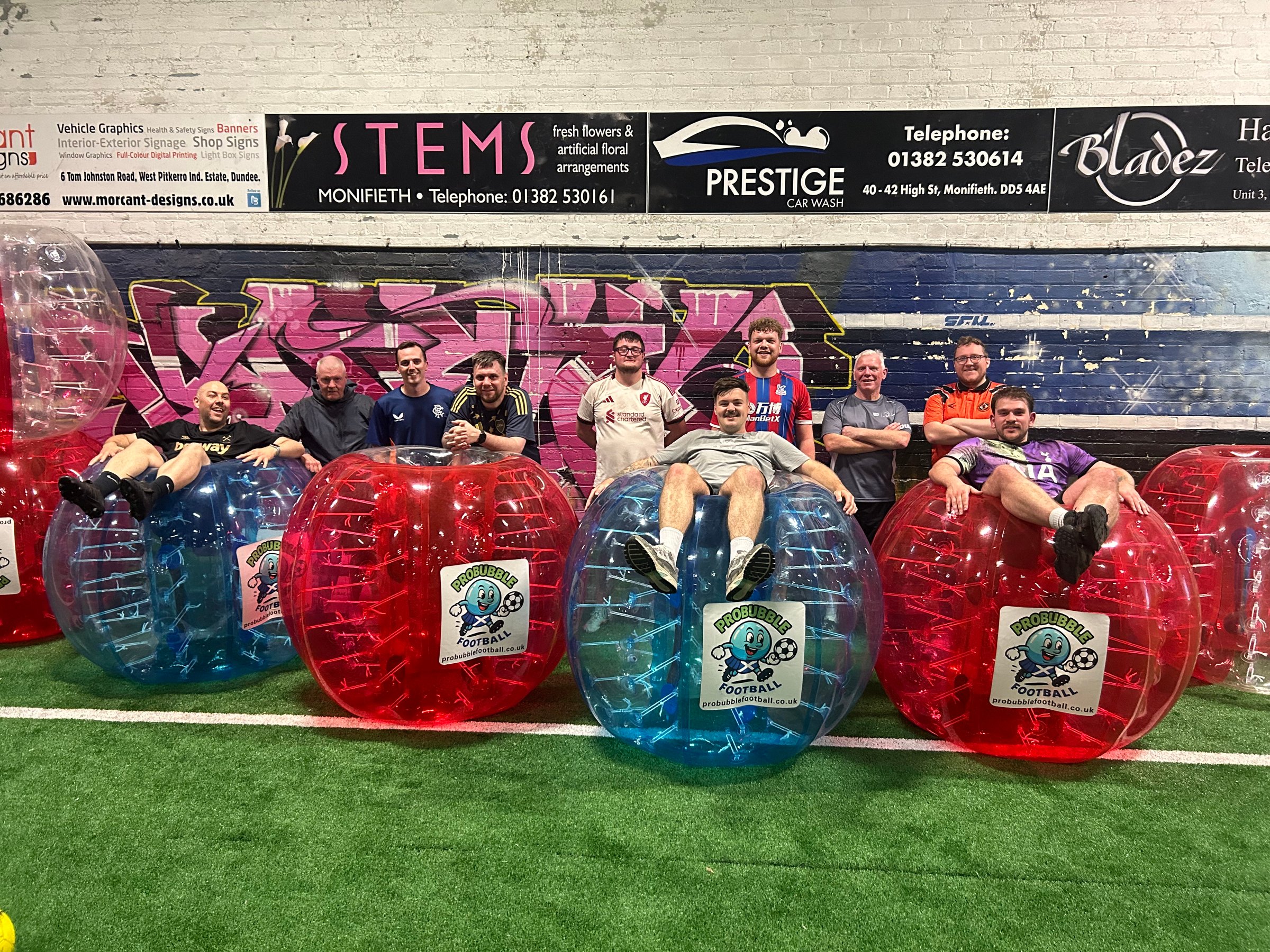 People playing bubble football outdoors