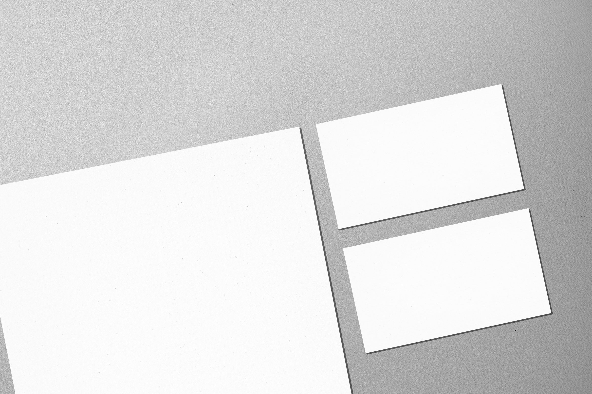 Top view set of business letterhead and business card on a gray background. Blank paper or sheet. Mockup or copy space for your design