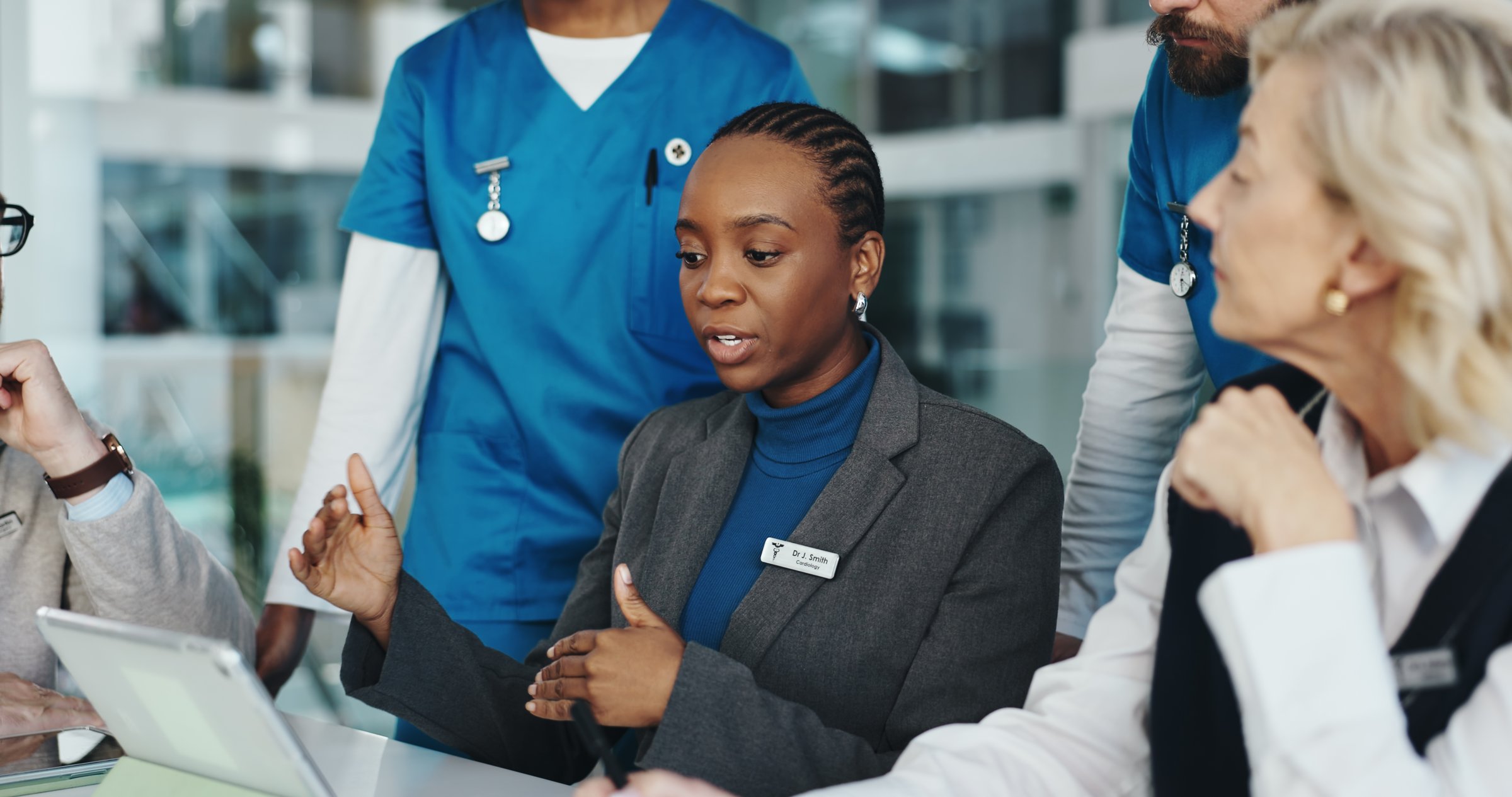 Doctors meeting with tablet in hospital