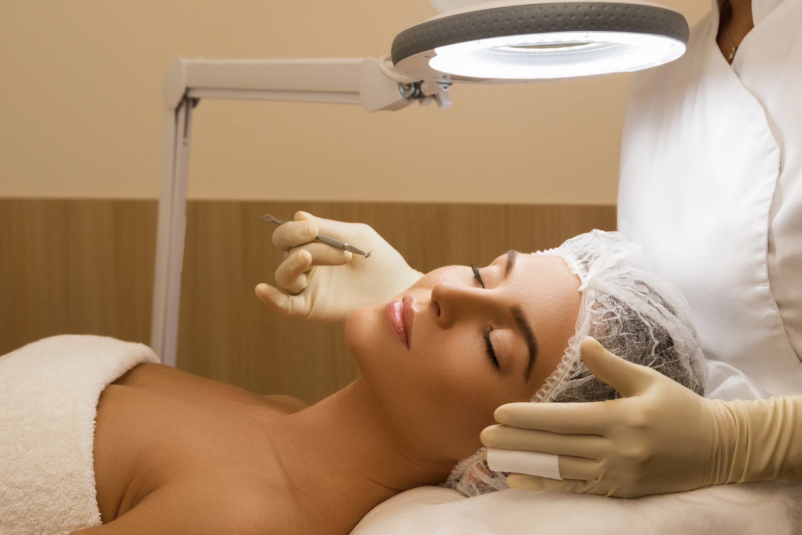 Woman in the professional beauty salon during a mechanical face cleansing procedure