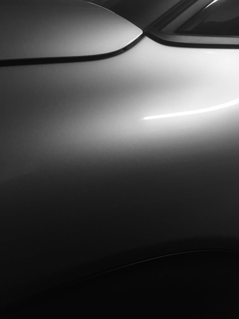 Abstract image of modern car side with smooth shiny surfaces in black and white
