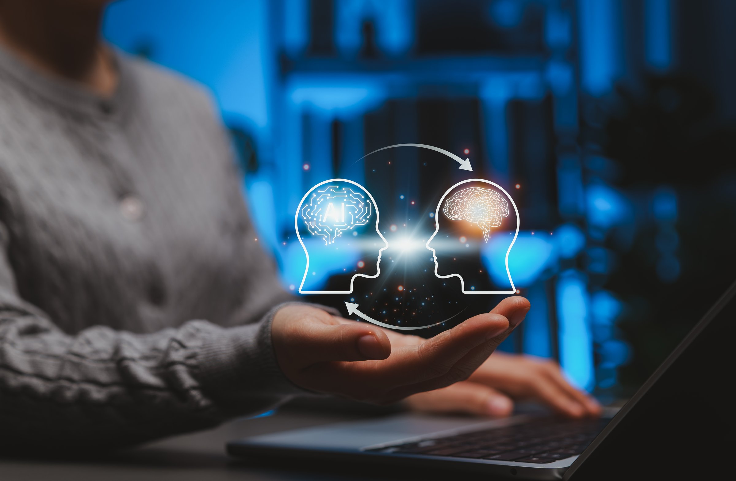 Human and AI Knowledge Transfer and Collaboration Concept. Person interacting with icons showing human brain and AI brain, symbolizing artificial intelligence, machine learning, and knowledge exchange