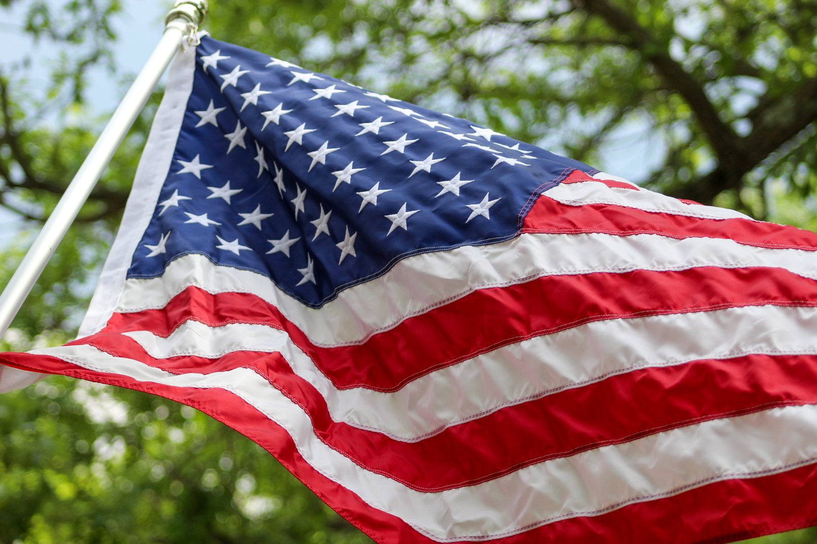 close-up of a united states flag waving in the breeze. detail can be seen in the fabric with folds and light effect.