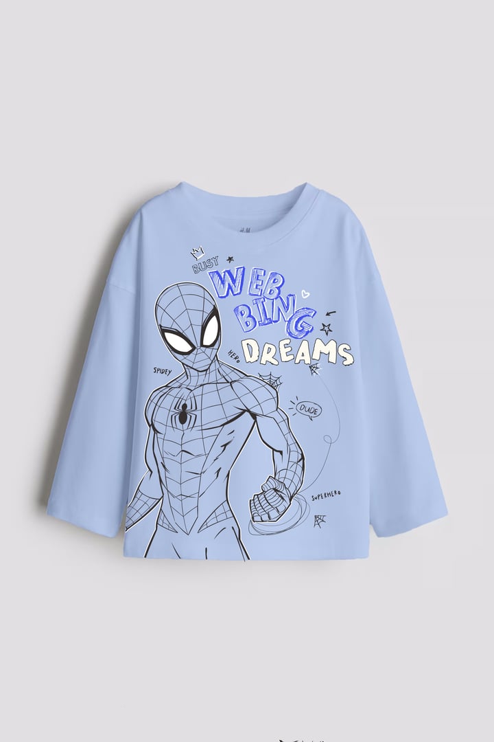 Light blue long-sleeved shirt featuring a Spider-Man sketch with text "WEB BLING DREAMS" and comic-style elements.