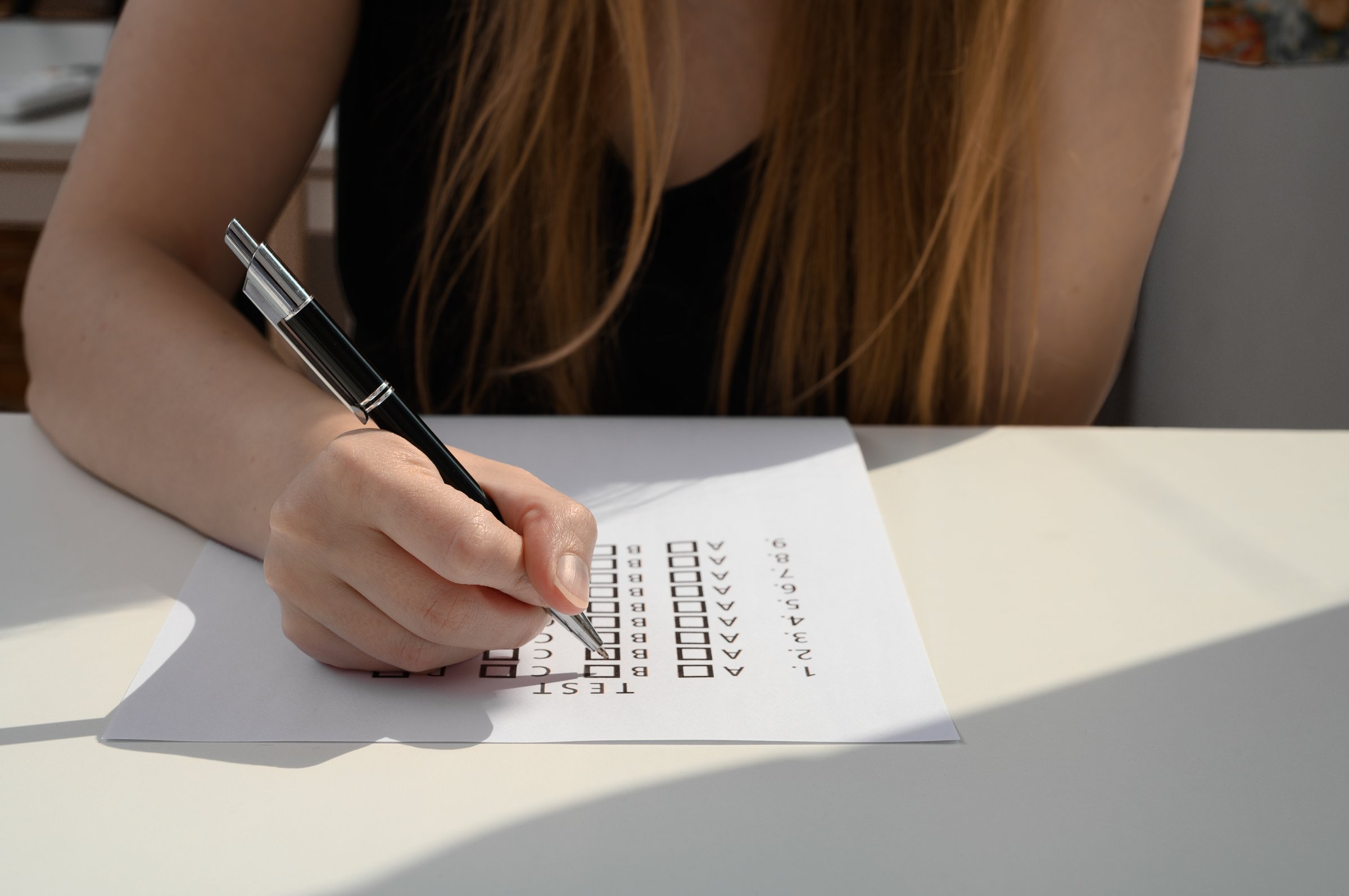 A girl in a tank top takes a college exam