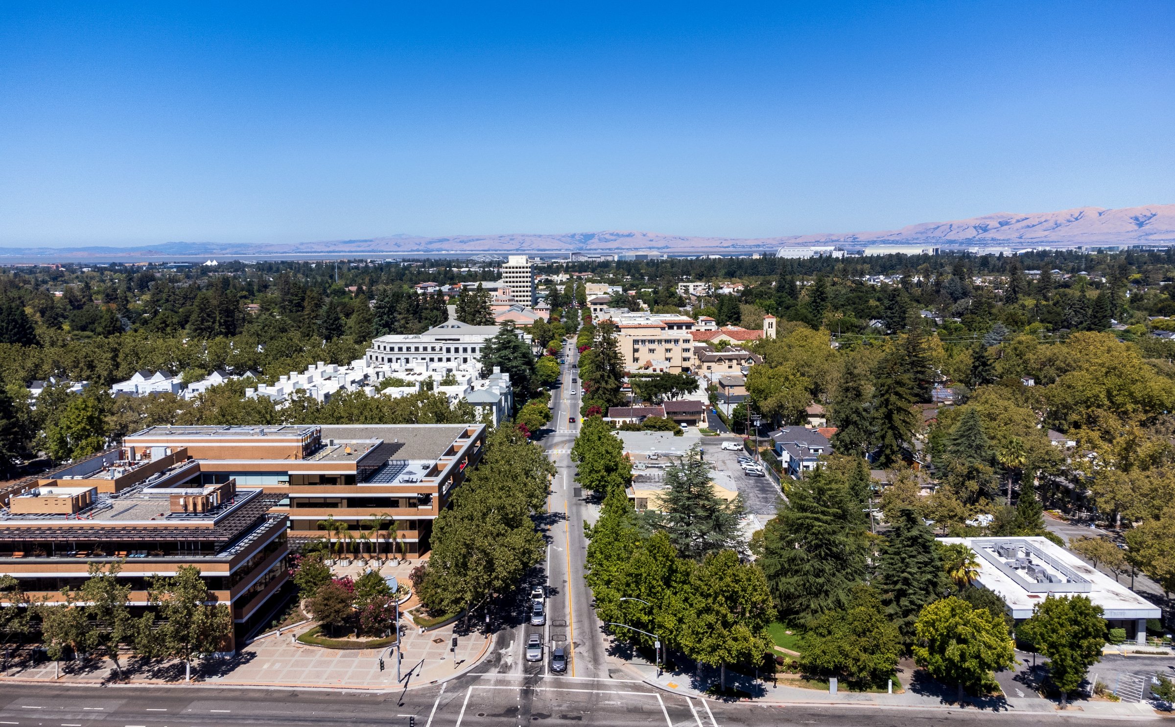 Aerial panoramic drone view of downtown Mountain View, California, along Castro Street, looking toward San Francisco Bay