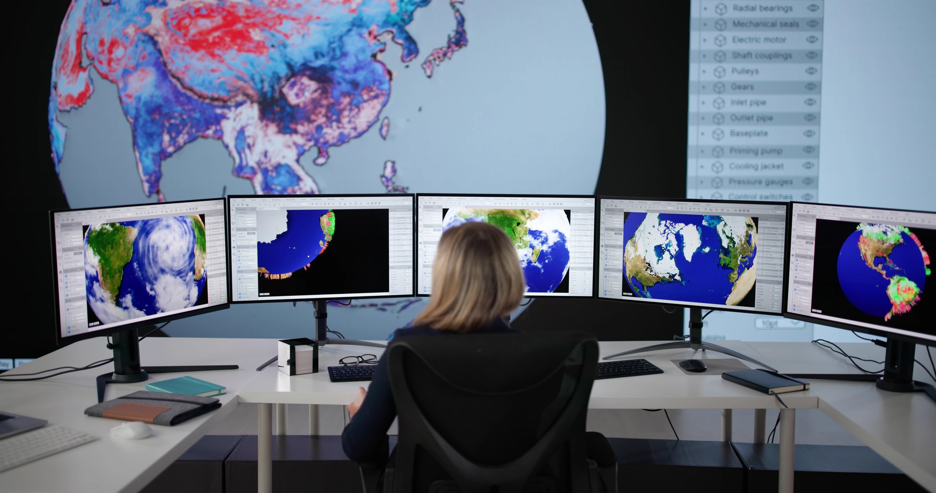 Female Scientist Using Computer To Analyze Global Weather Forecast Map