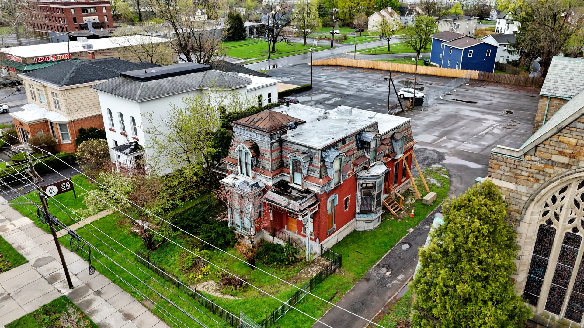 Aerially circling a building that is in need of drastic repairs that could invigorate a community through its aesthetic appearance if restored.