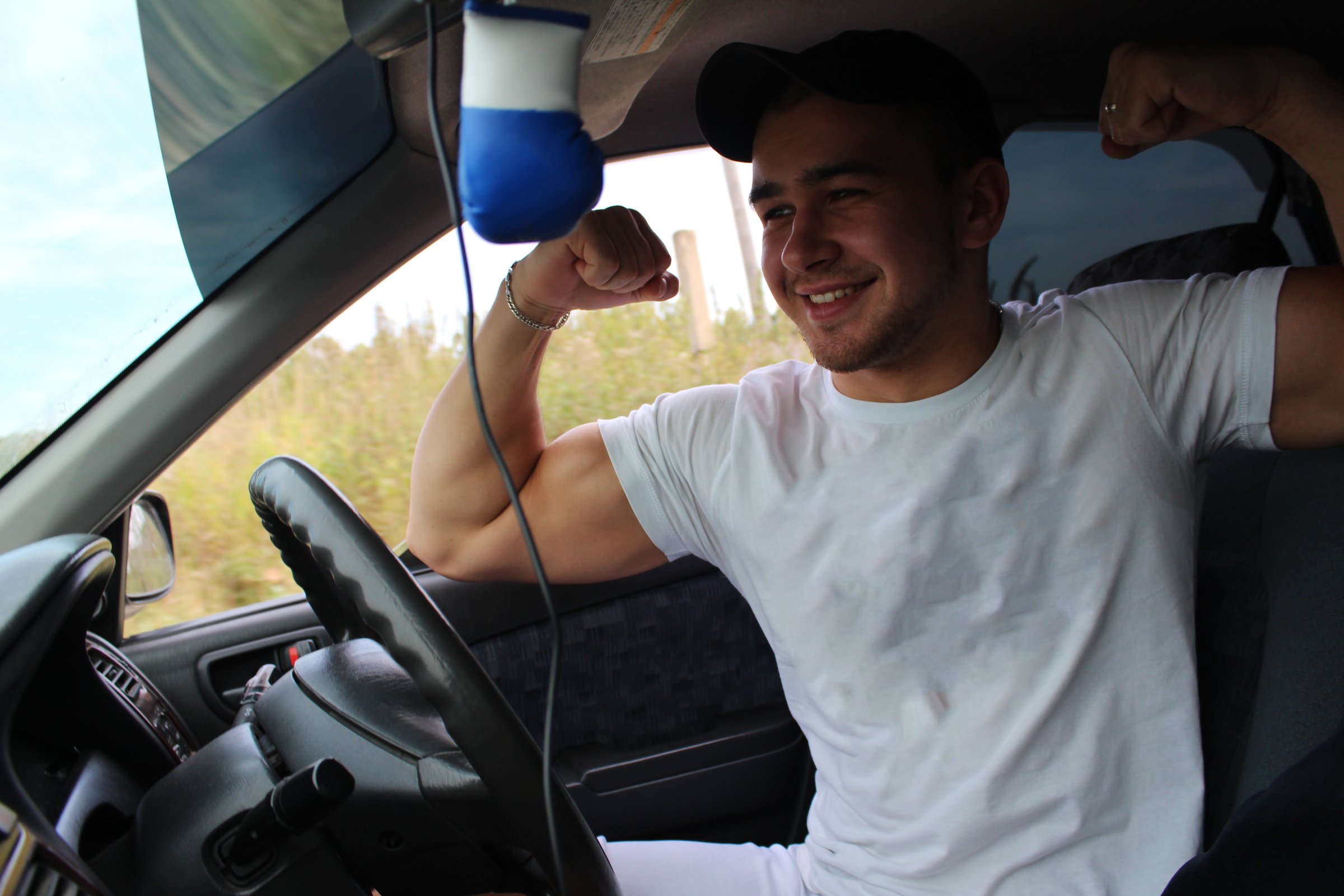 The guy in the white shirt behind the wheel