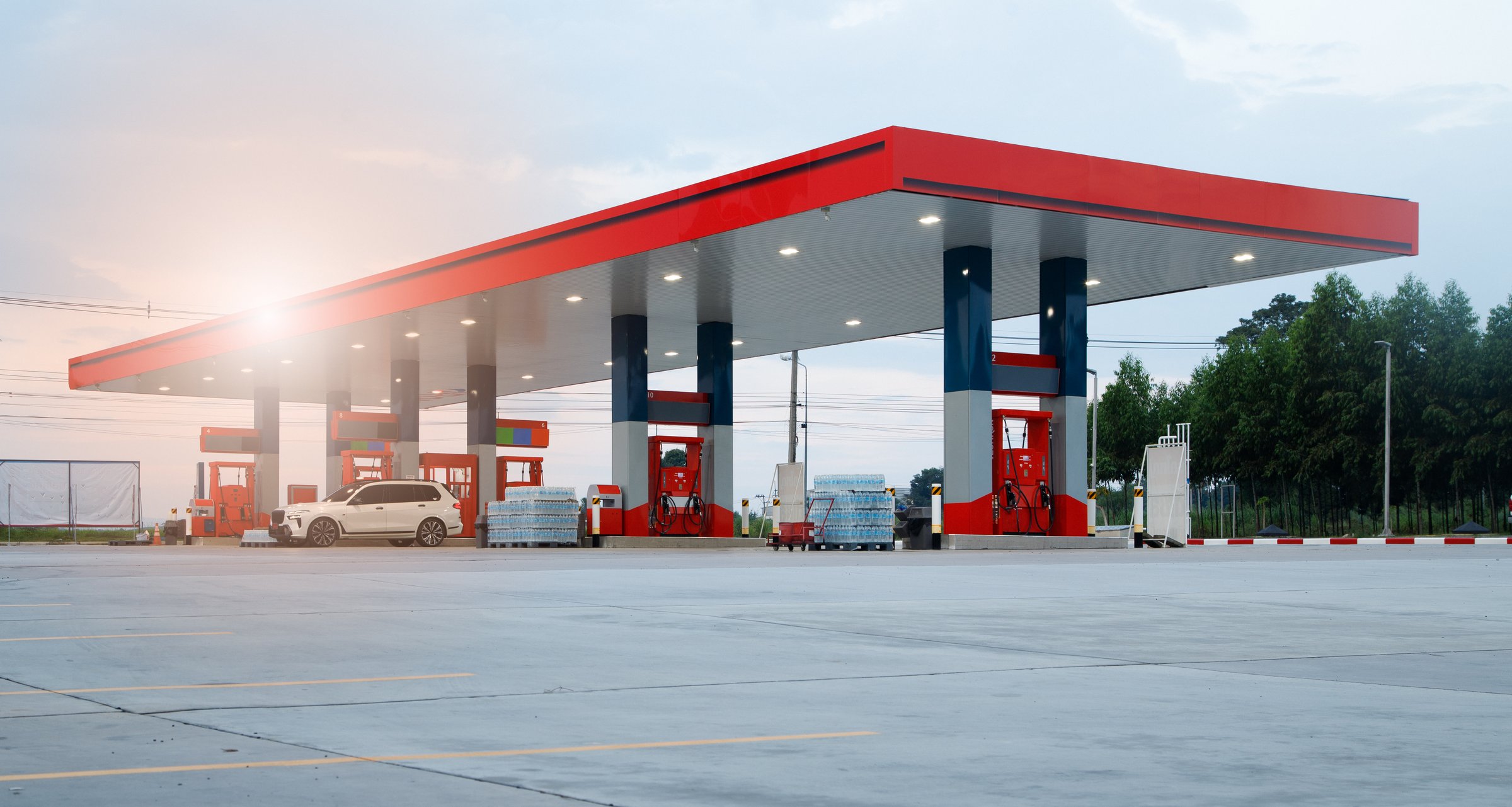 Gasoline pump nozzle sign. Fuel pump petrol station,Oil and Gas station at sunrise and orange sky .