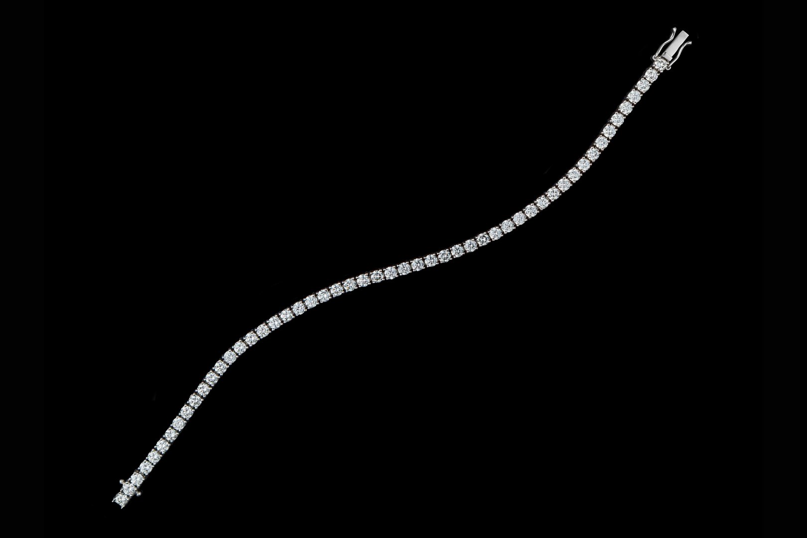 bracelet silver, gold with stone diamonds on black background close-up