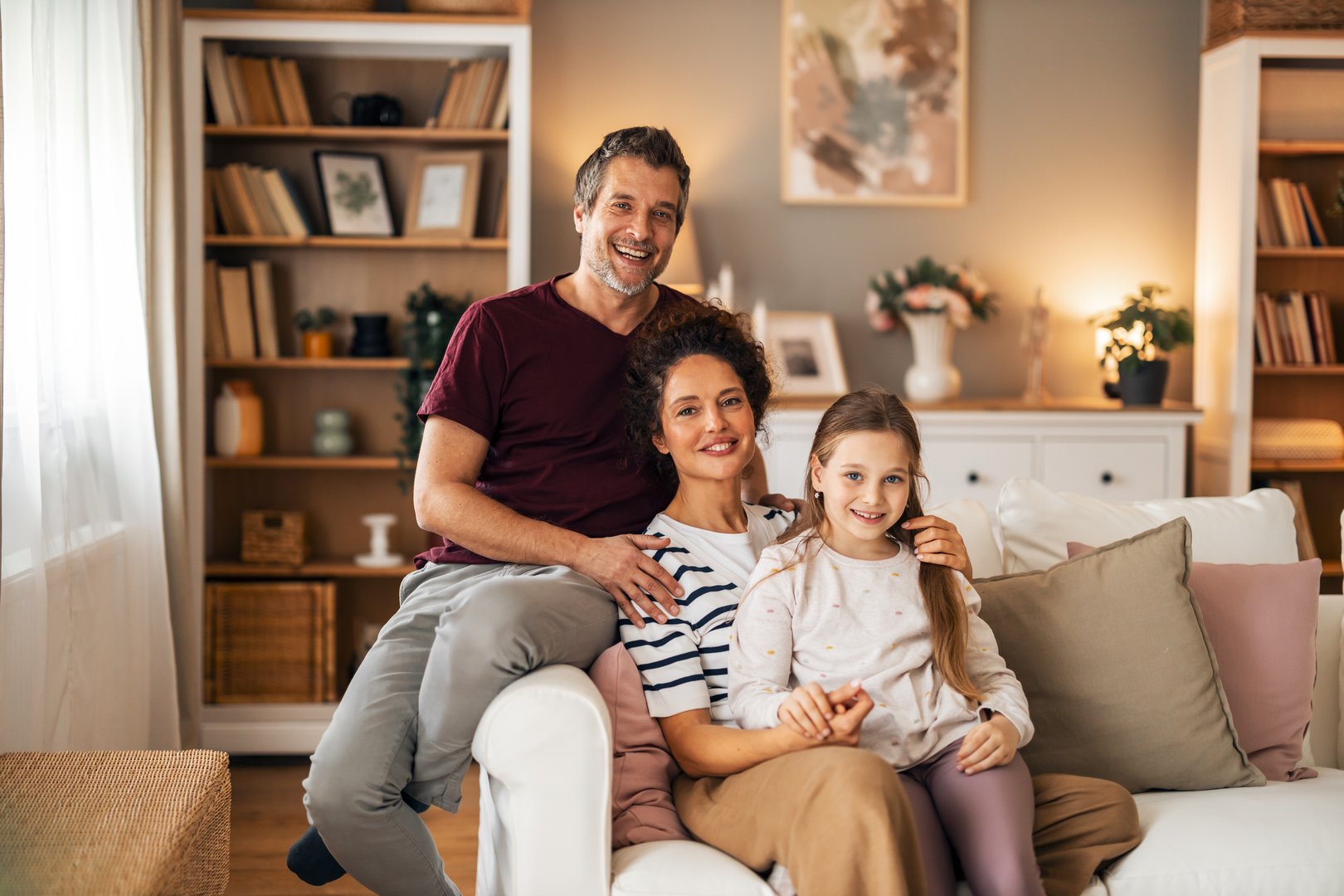 A loving family enjoying quality time sitting together in a cozy, inviting living room.