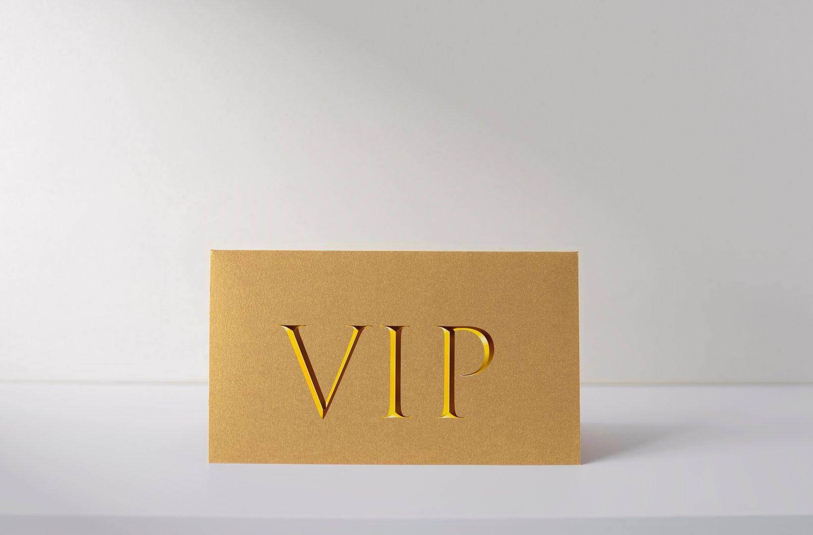 Golden VIP card on white desk, ID card for VIP persons, business concept picture