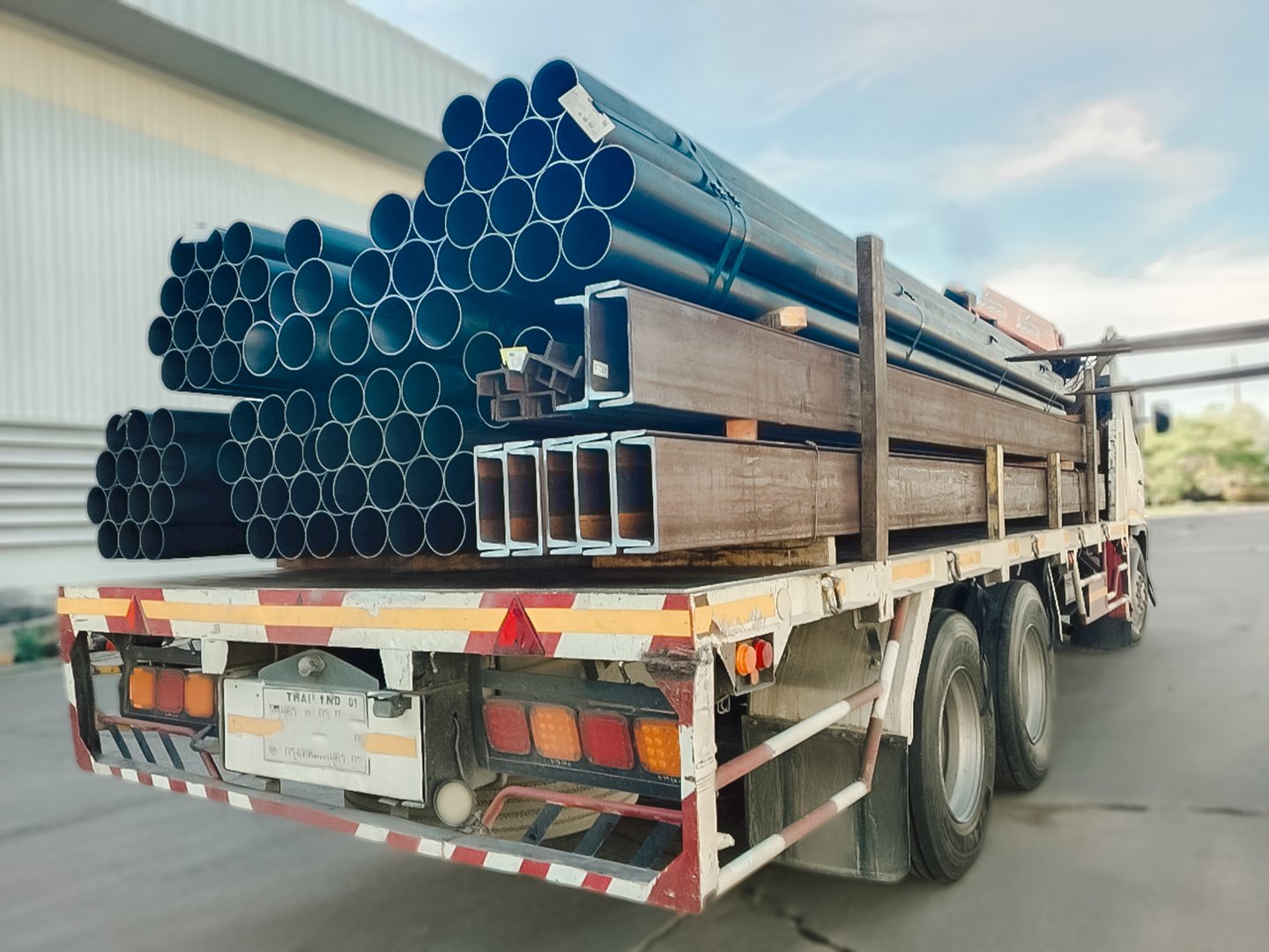 Stacked steel pipes with Construction steel, black pipe,Metal tubes, Angle steel, flat pipe, square pipe, close-up monochrome photo with selective focus,Stack of Many Pipes at the Construction Site