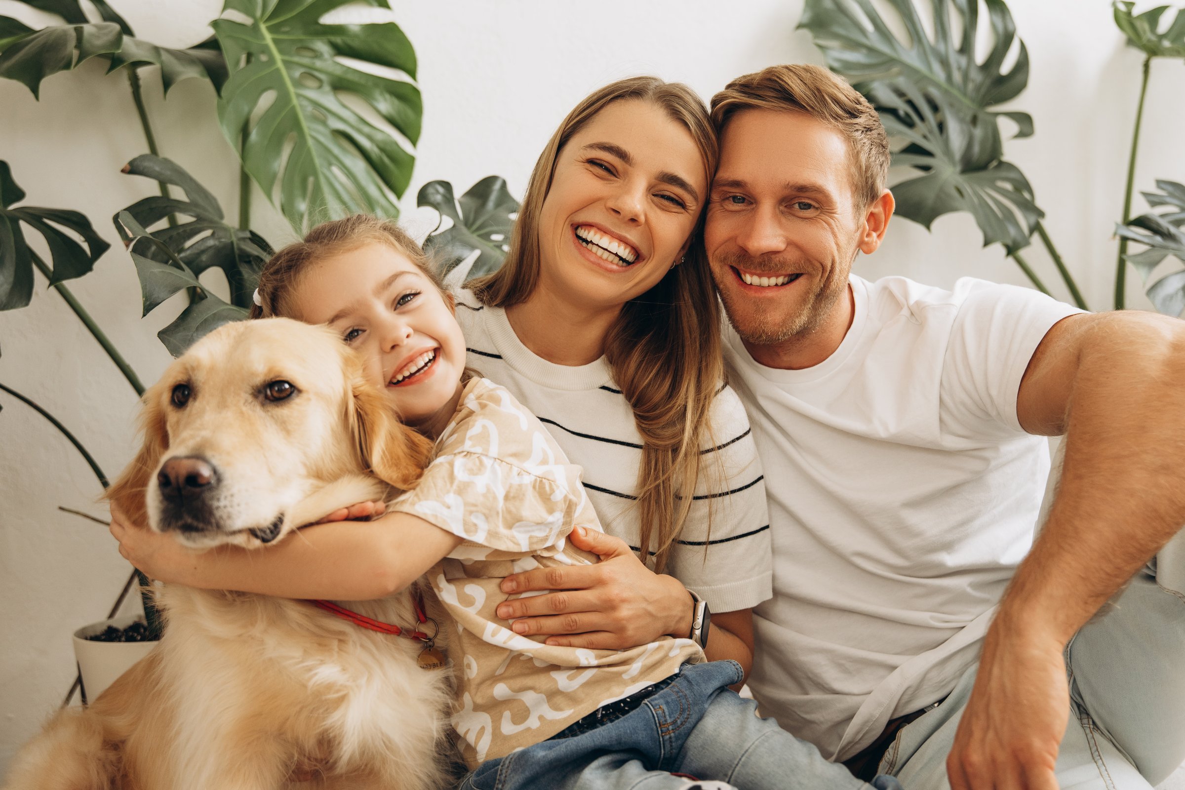 Sugarfree.space family wellness - Portrait of smiling family, happy mother, father, cute, little daughter hugging together with dog