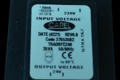 Label displaying electrical specifications: input voltage 230V, output voltage 24V, and other technical details.
