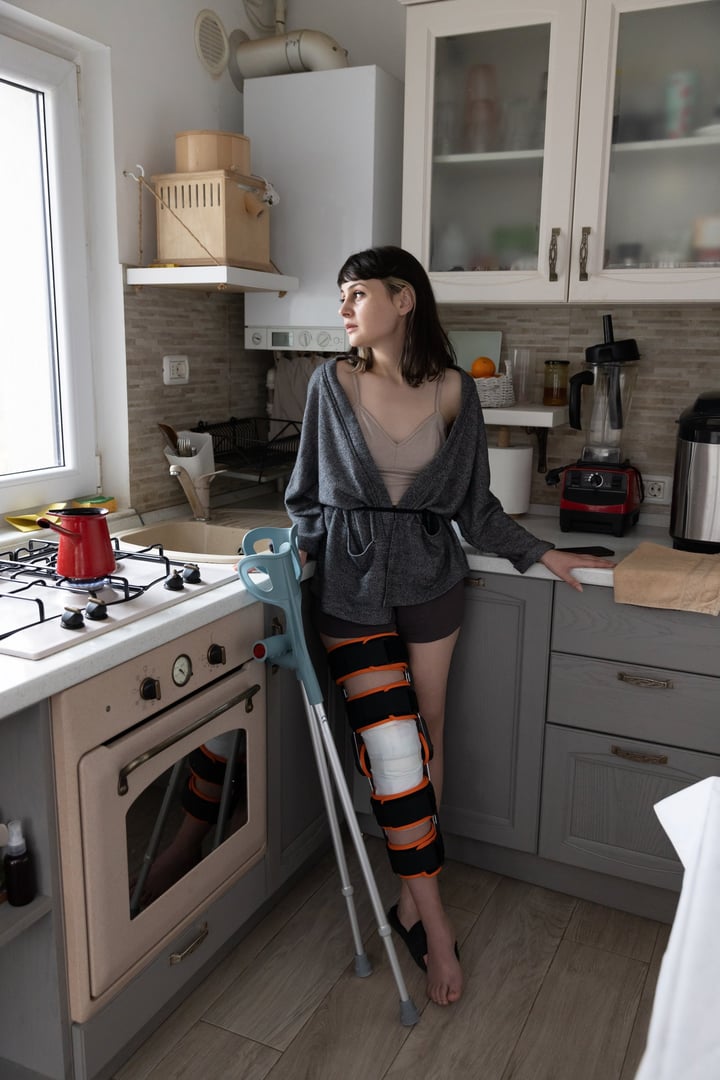 Young woman in the kitchen waiting for her coffee to be ready.