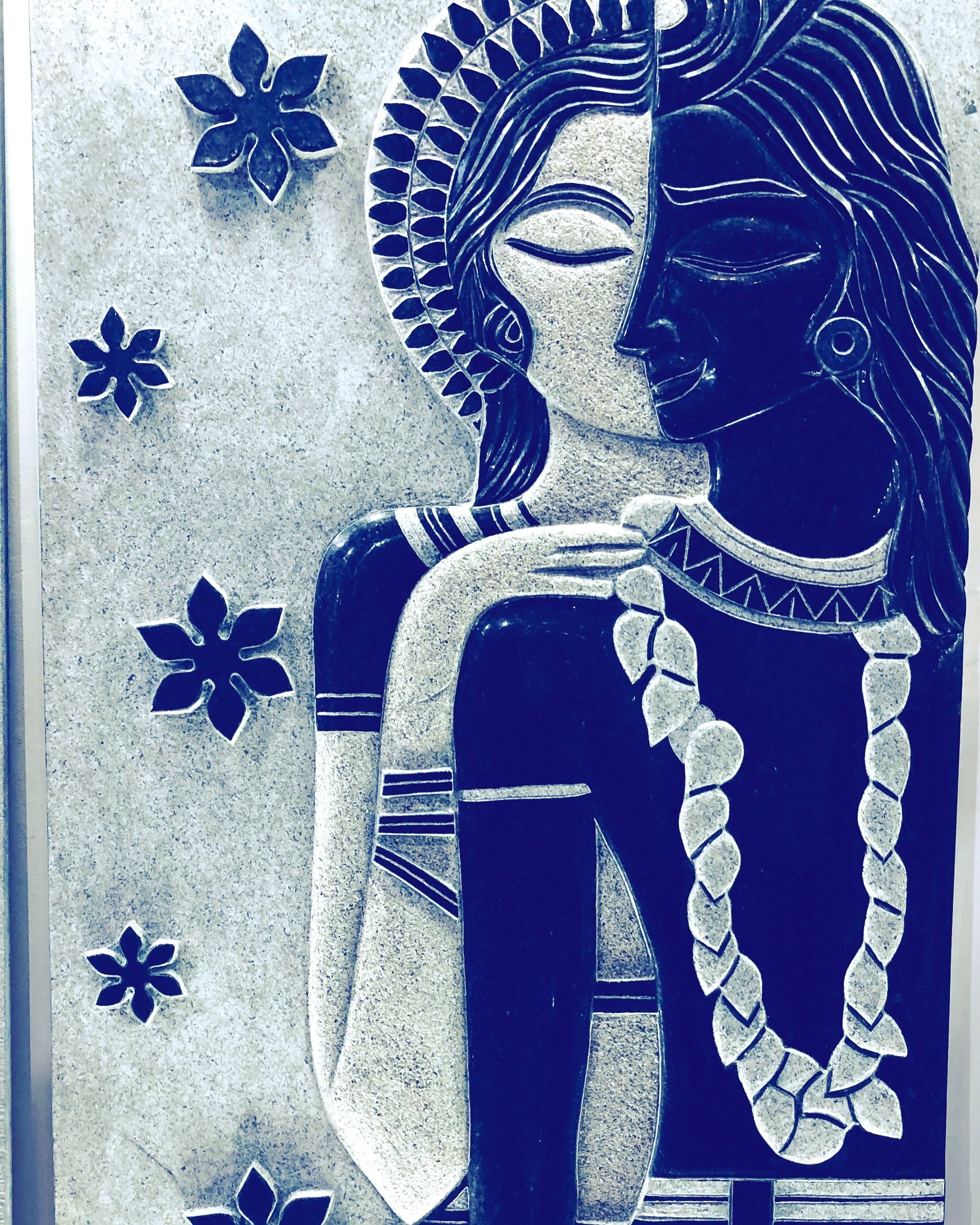 Abstract art of a couple, intertwined with floral patterns. One face is light, the other dark, set against a textured background.