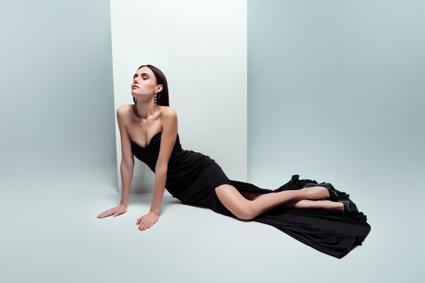 Photo of chic attractive lady posing over white banner on photosesion wear black gown isolated grey color background.