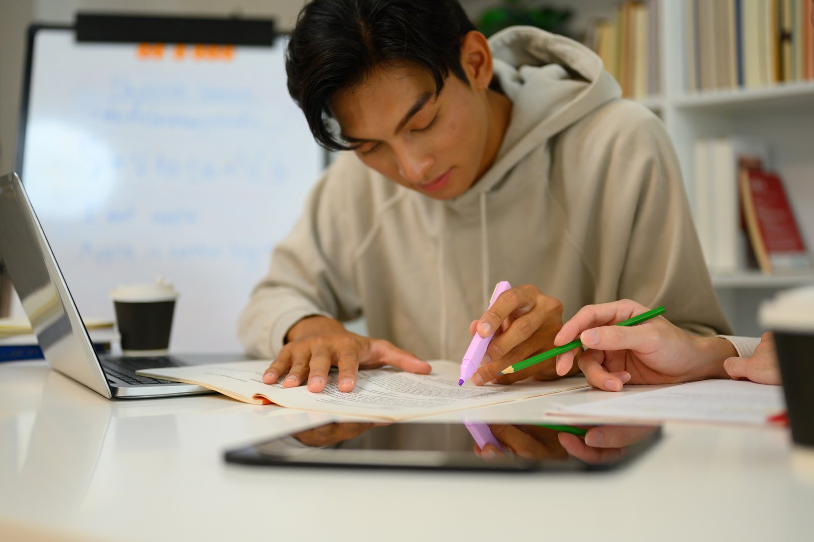 Asian male student studying with tutor at home. Education, knowledge and tutoring concept.