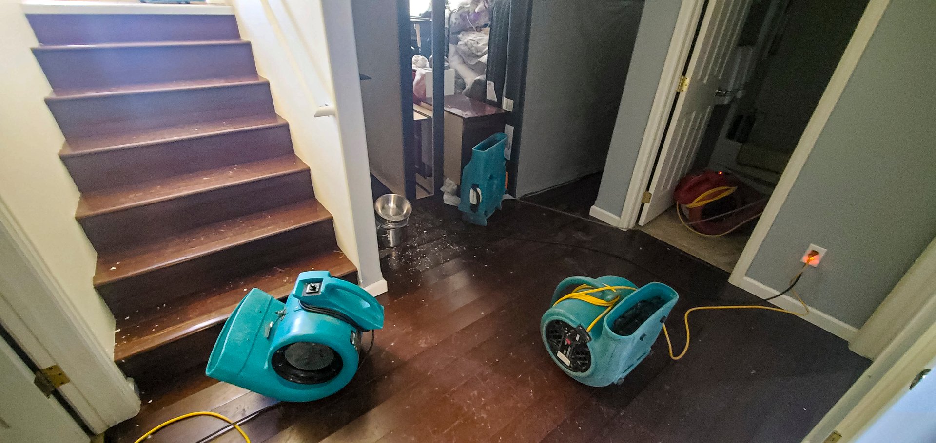 Air movers set in place to dry out a home after a water damage flood caused by a pipe break.