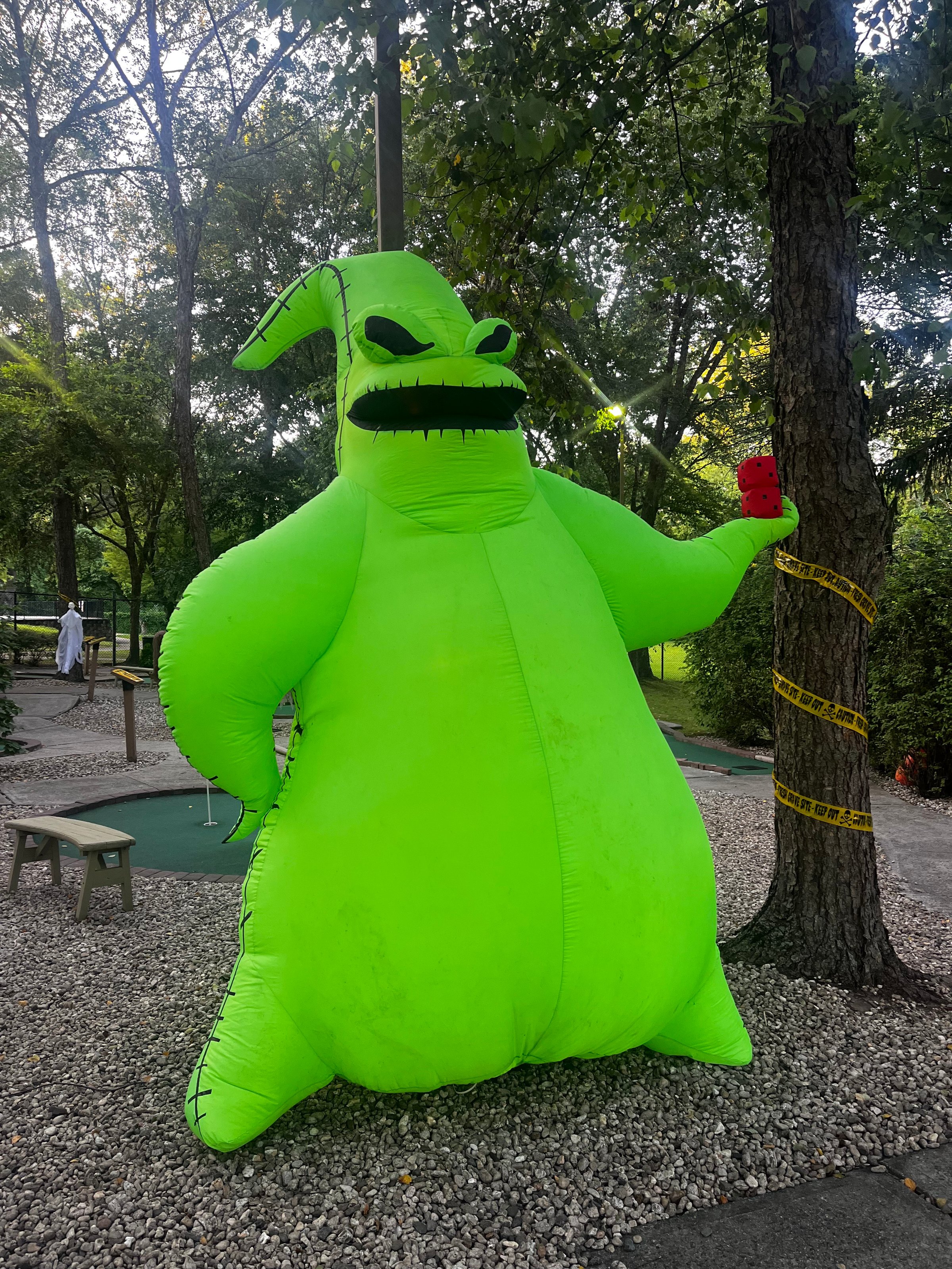 Mystical Halloween mini golf scene with fog effects and ghostly atmosphere