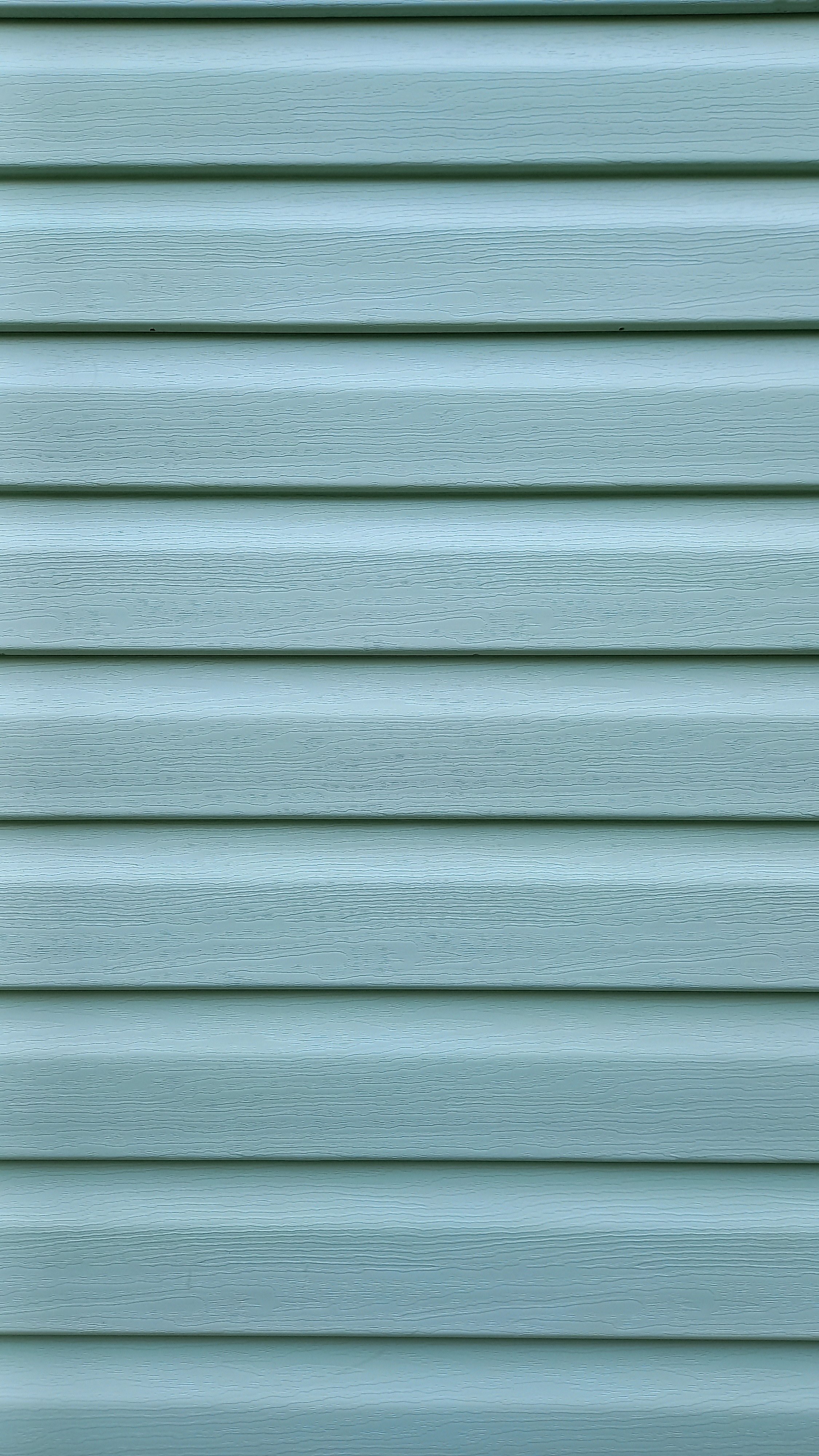 Cyan-greenish siding for exterior house wall trim. Vertical Background.