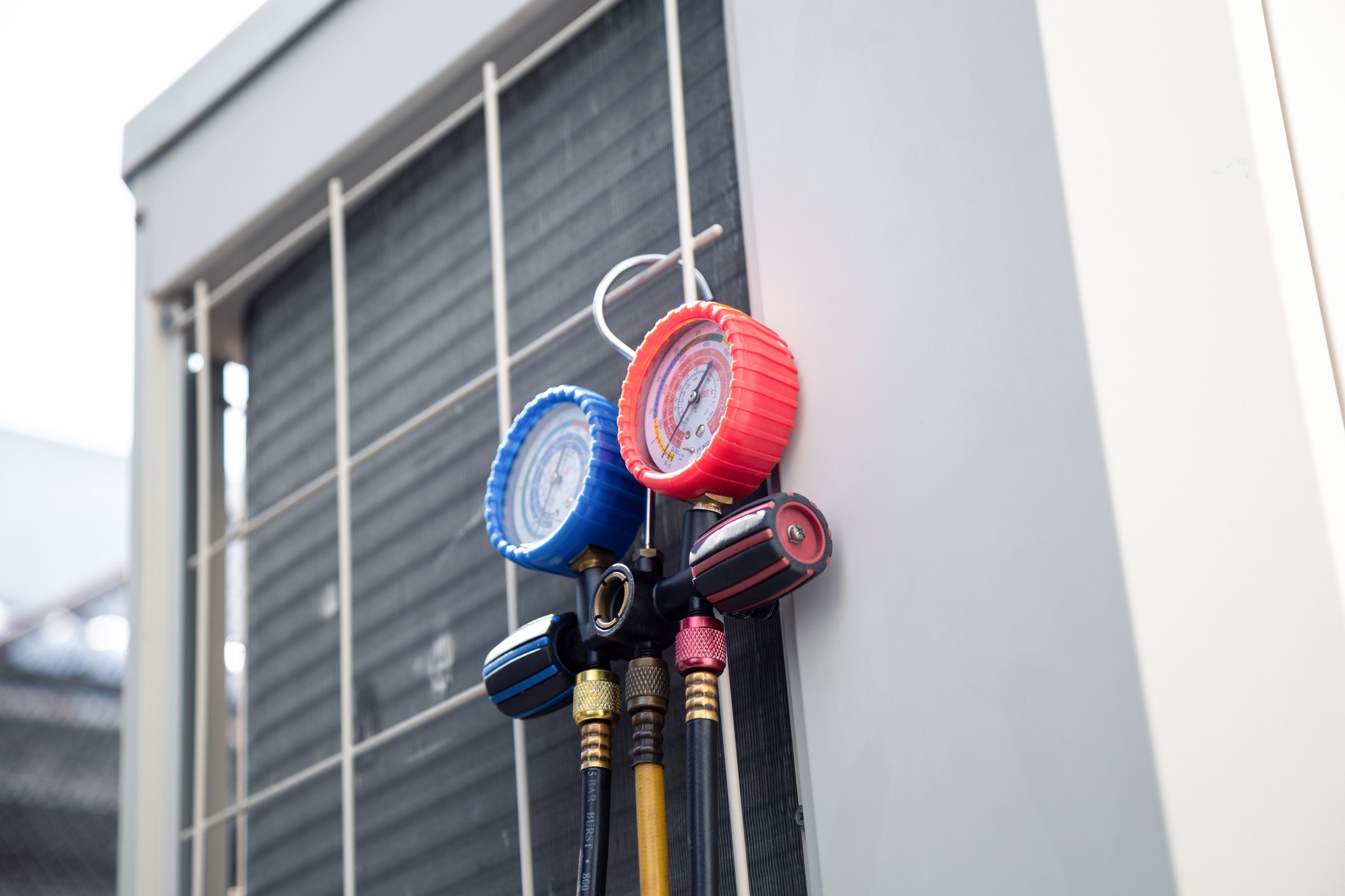 Air conditioning service,HVAC Using a gauge to check the refrigerant in the system. Concept of inspection and maintenance services