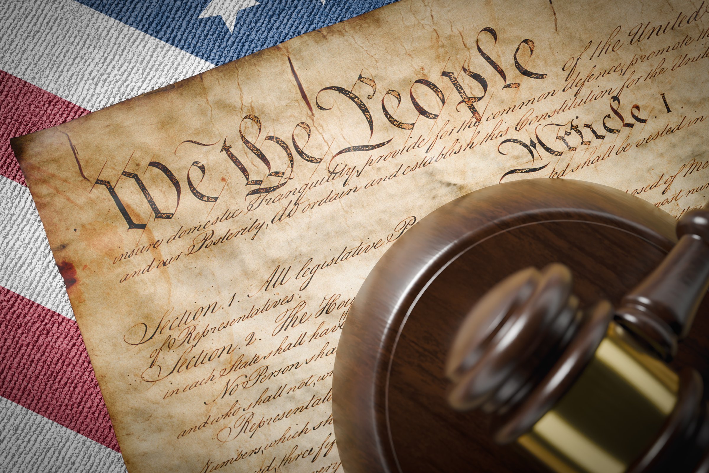 United States Constitution, Gavel and American Flag Resting on Table.