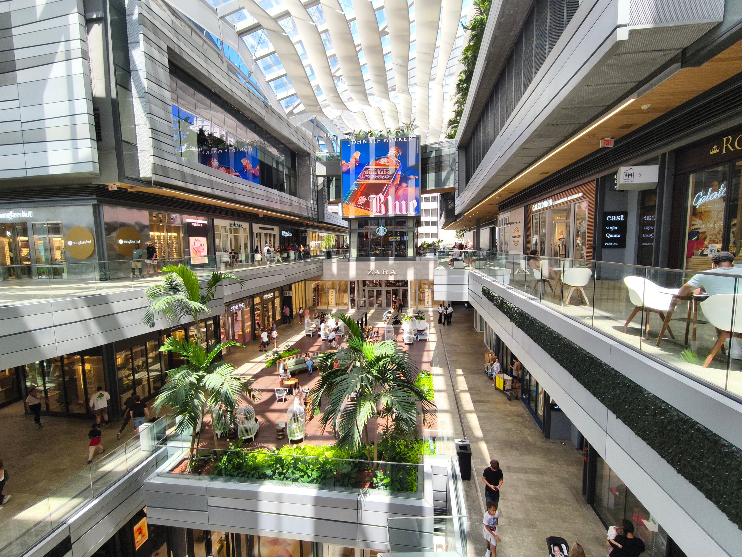 Miami, Florida - July 5, 2024: Brickell City Centre shopping mall in Miami, showcasing modern architecture, shoppers, retail stores, and open spaces.