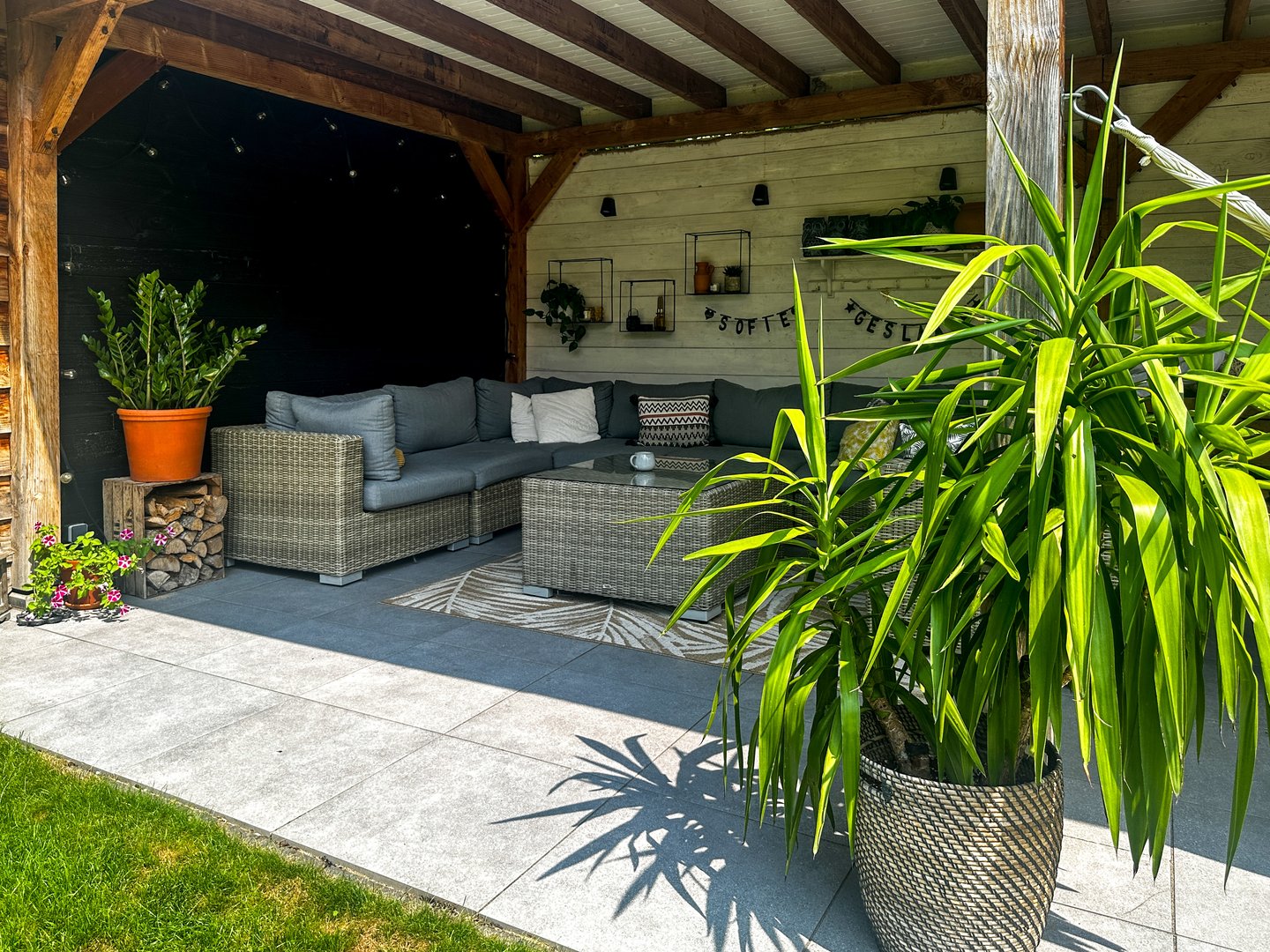Wicker sofa patio with potted plants