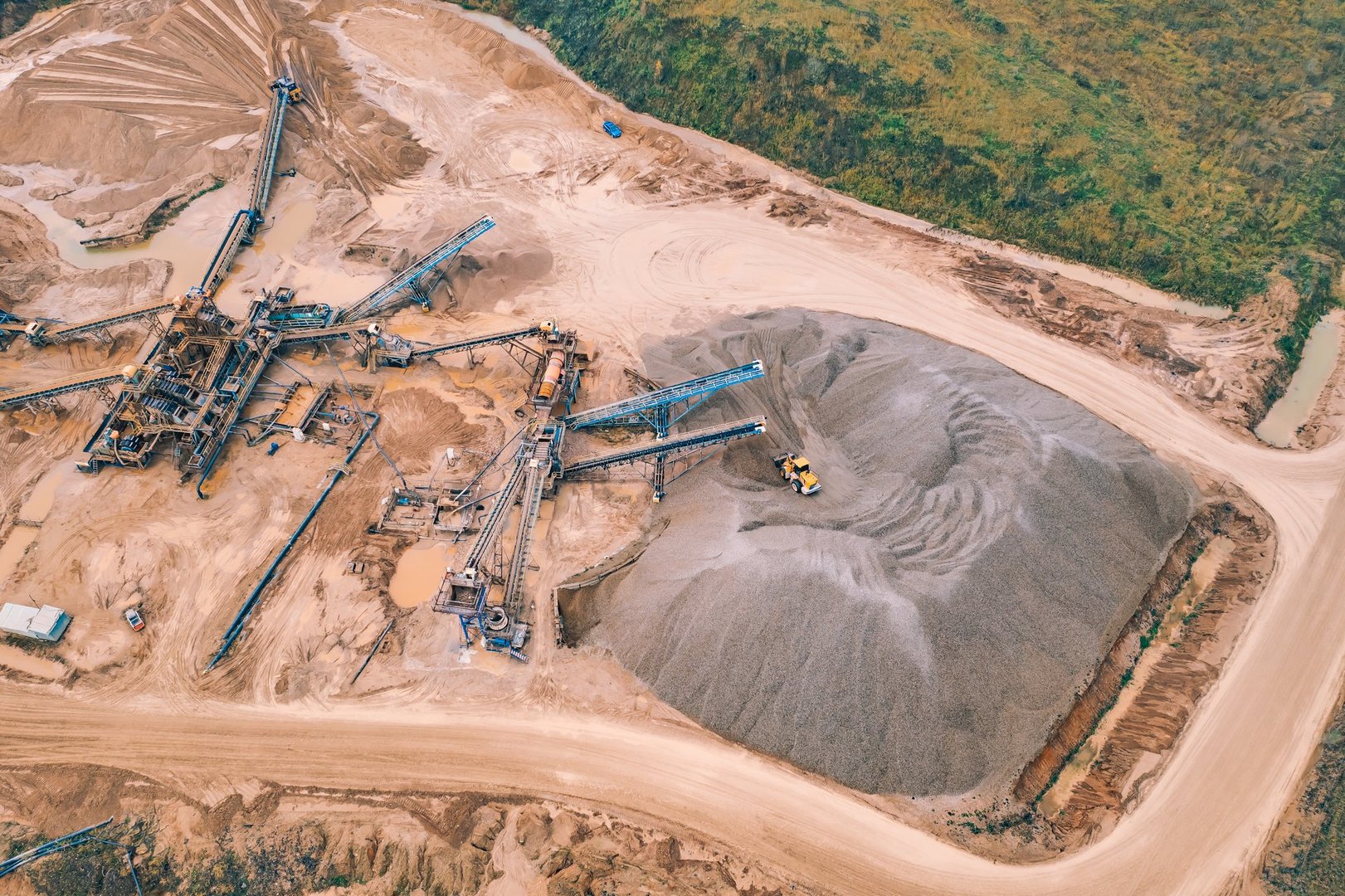 Aerial top view of open pit development and sand extraction. Mining industry Reserves.