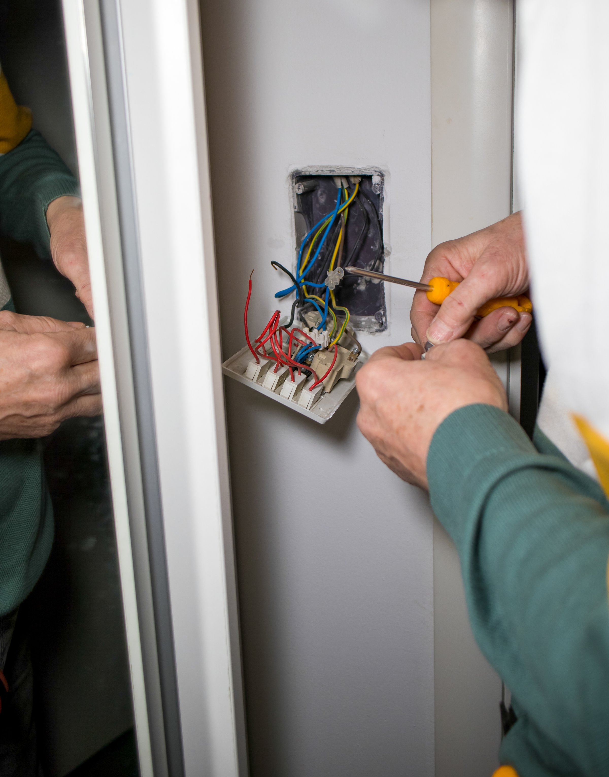 electrician repairs an electrical switch at home