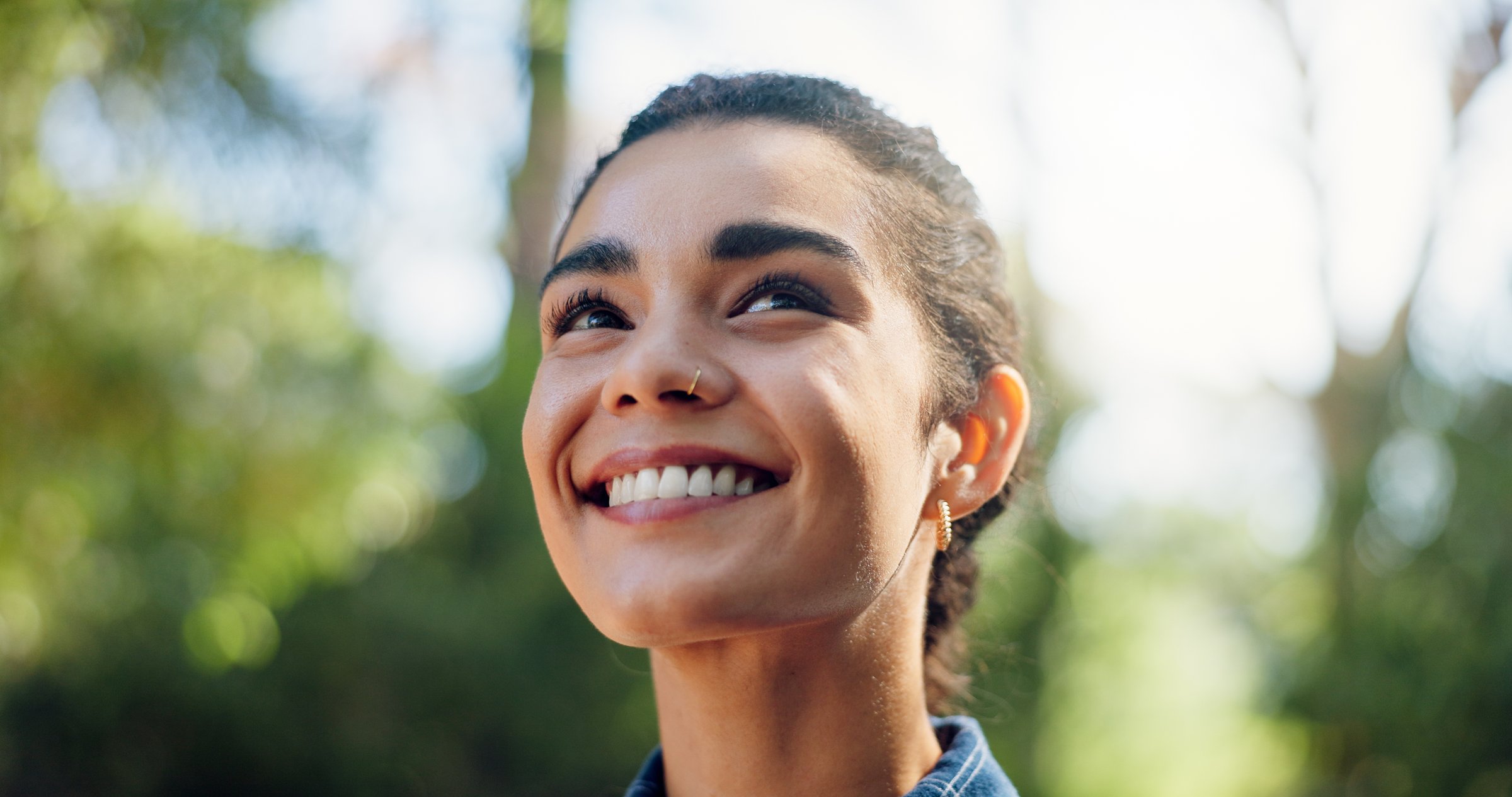 Thinking, hiking and woman with nature, smile and contemplation with hobby, explore and travel. Outdoor, hiker and happy person in woods, vacation activity and sightseeing with environment and break