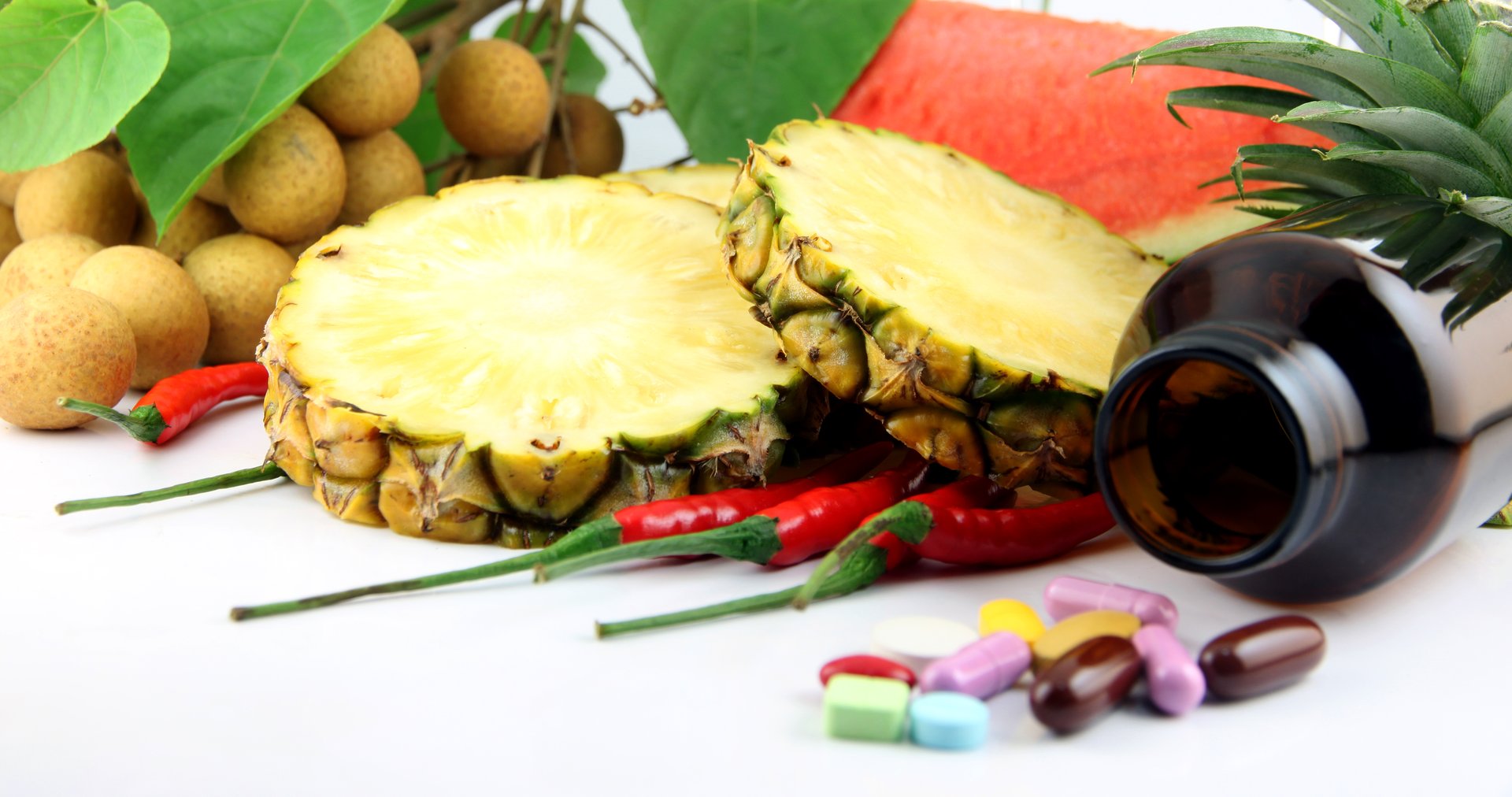 Fruits and medicines placed near the cosmetics and Vegetables on white background.