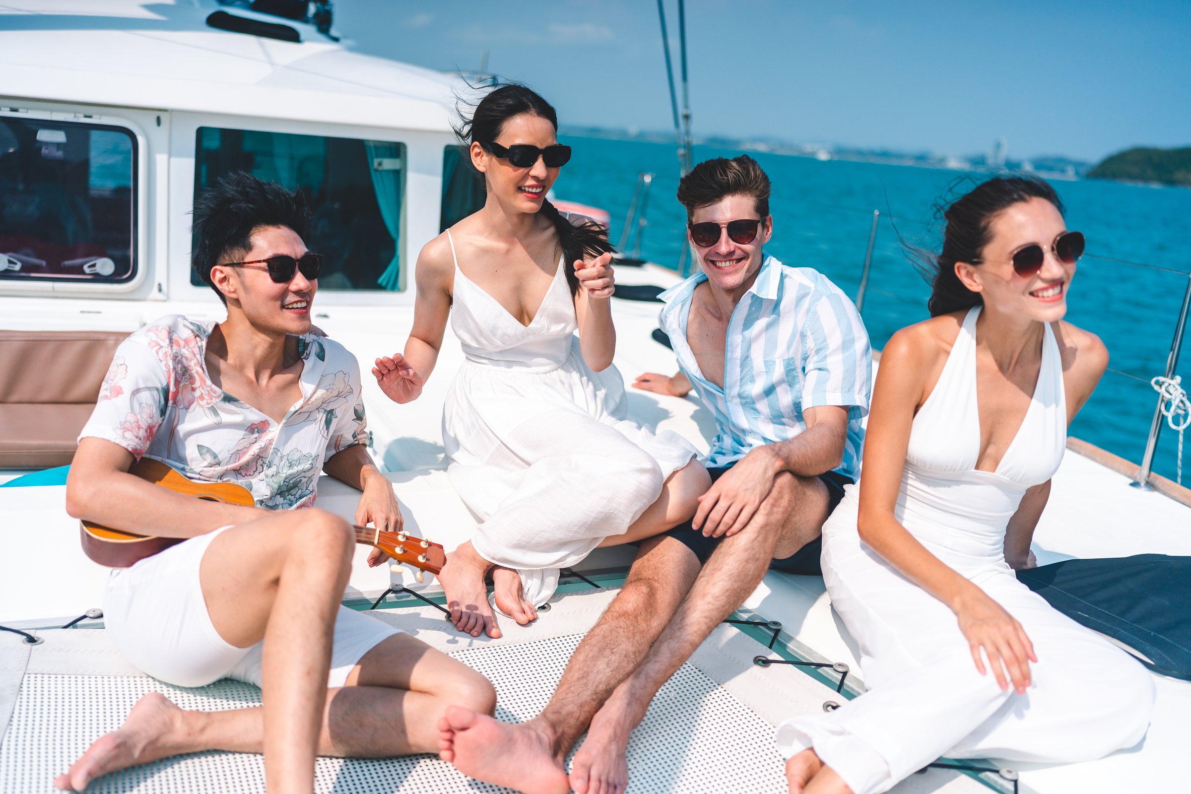 Caucasian couple who man and woman relax fun with luxury party drinking champagne by talking together while catamaran yacht boat sailing. Happy and enjoy outdoor lifestyle on summer vacation travel