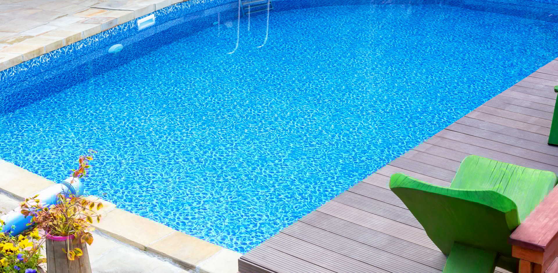 Clear blue swimming pool in yard. Rest and relaxation