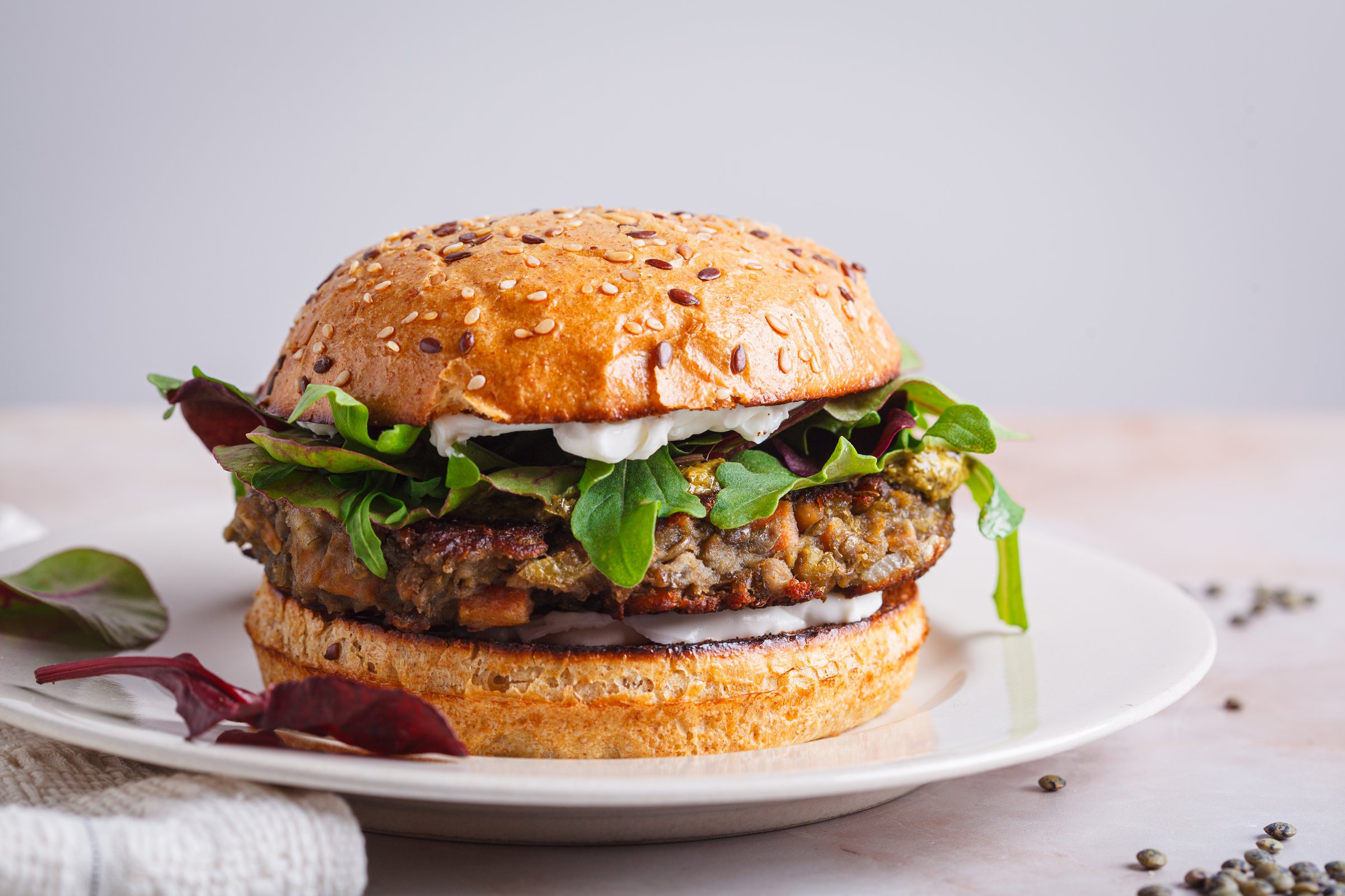 Vegan burger with lentil cutlet, pesto and vegan cream cheese.