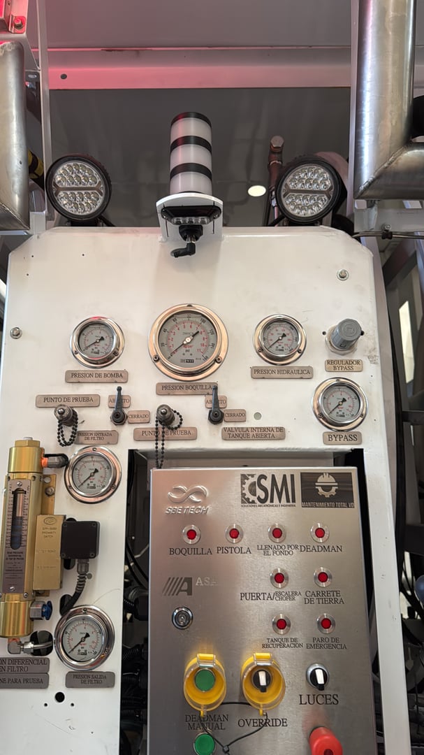 Control panel with dials, gauges, and buttons for operating industrial machinery, labeled SMI and ASEA.