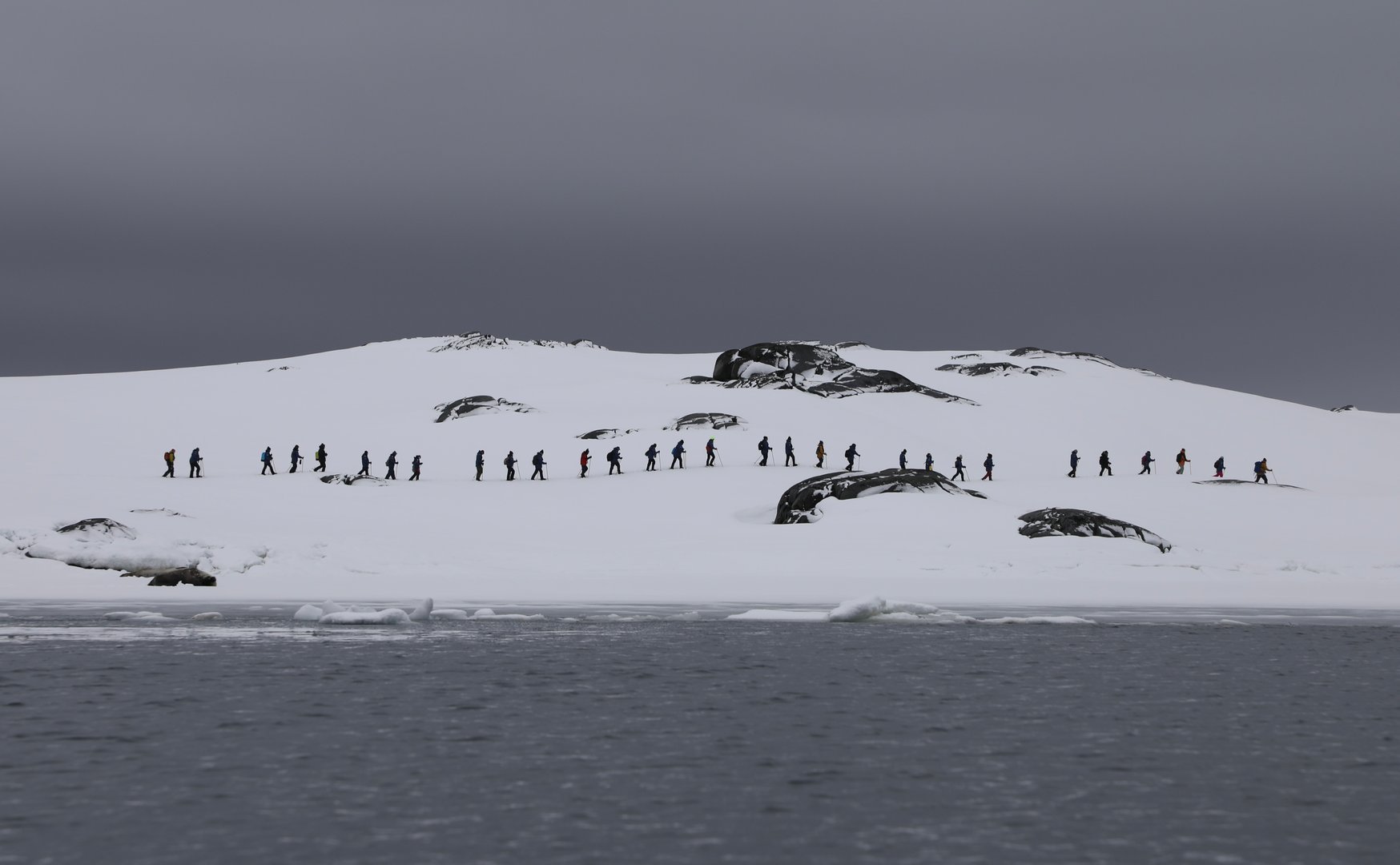 Hikers in single file in Antarctica