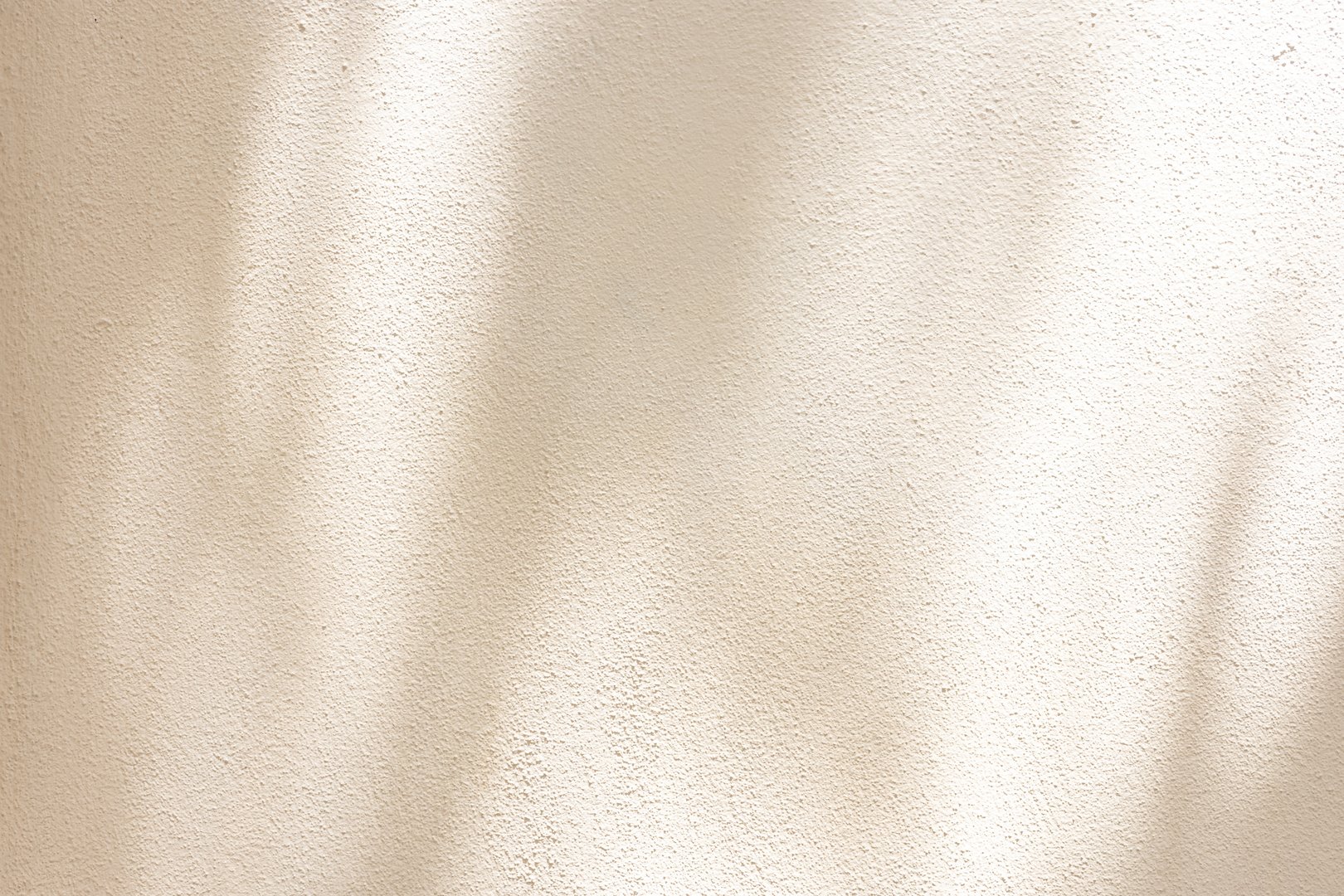 close up on beige plain wall background texture with shadow of window from sunlight for ads and advertisement product such as cosmetic or content or goods design display concept