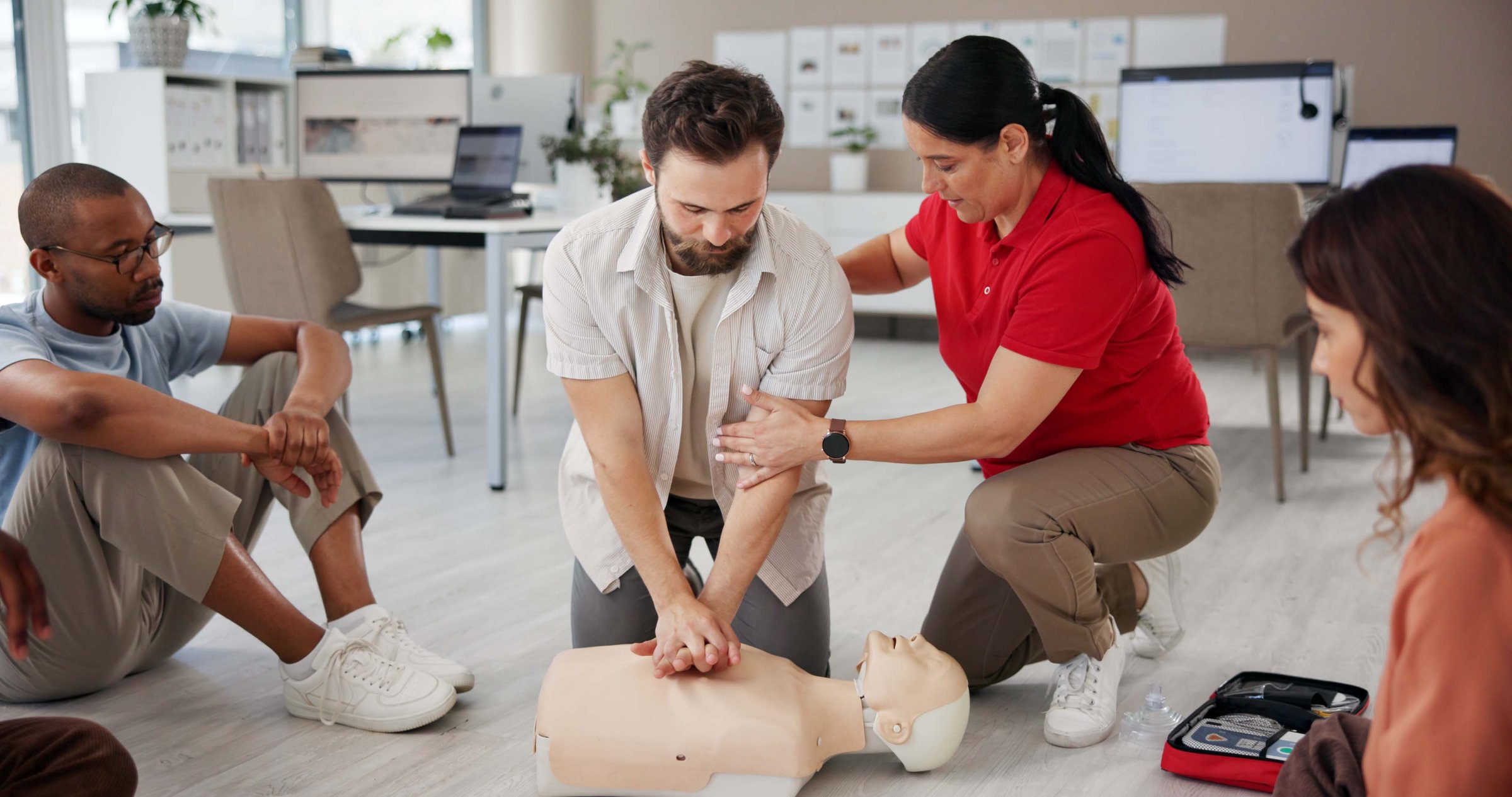 First aid, learning cpr and people with mannequin for safety compliance, health or chest compression for breathing. Paramedic course, medical and teaching group emergency rescue technique in office